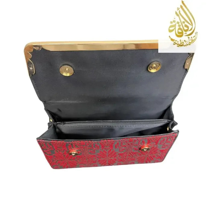 Open red kuffiyeh handbag with black interior lining and gold button closures