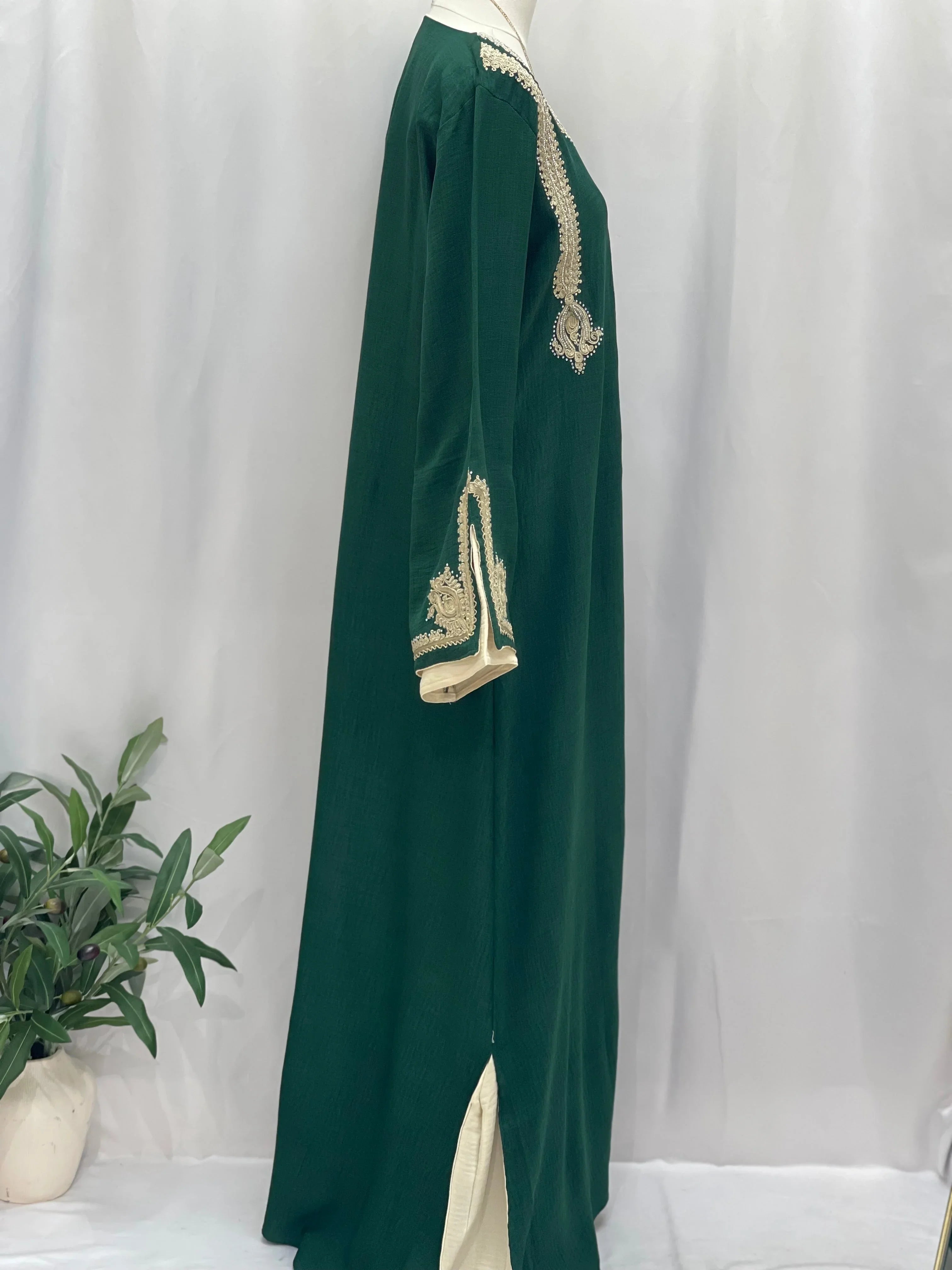 Regal Moroccan Jalabiya by Palestinian Elegance green floor length with gold embroidery cream inner hem
