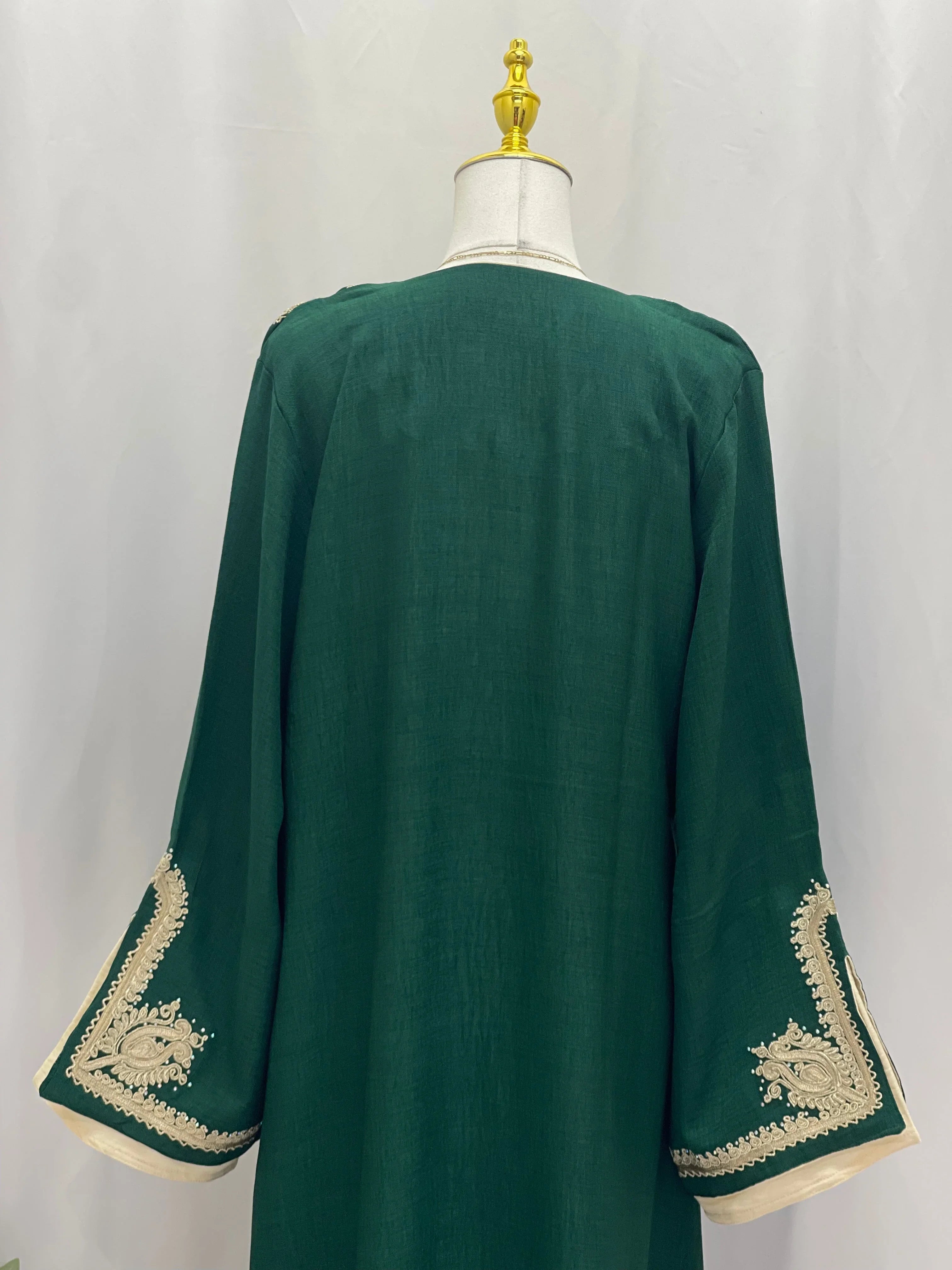 Regal Moroccan Jalabiya deep green back view on mannequin with cream gold embroidered wide sleeves