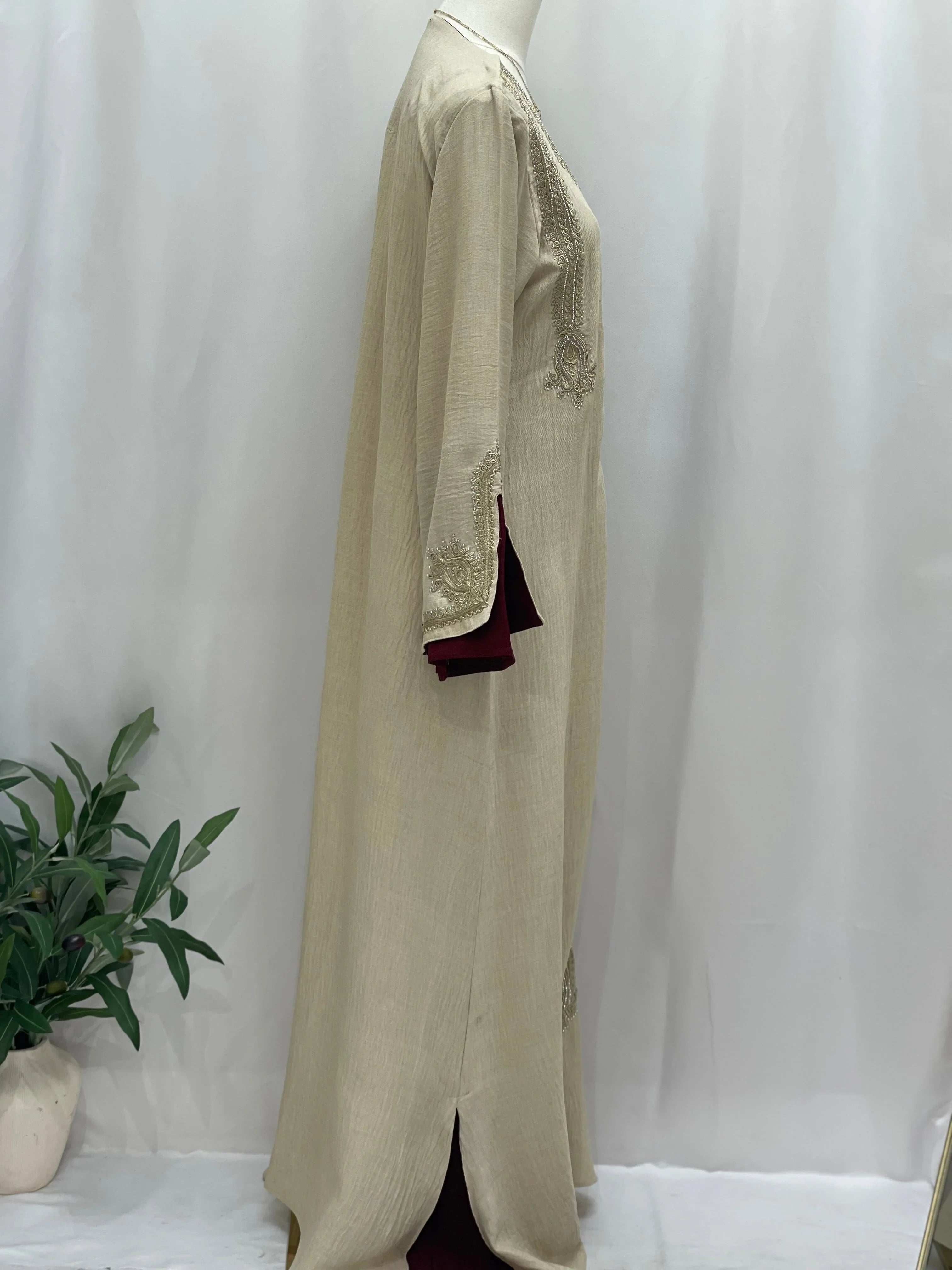 Palestinian Elegance Regal Moroccan Jalabiya beige embroidered long dress with burgundy inner lining side view
