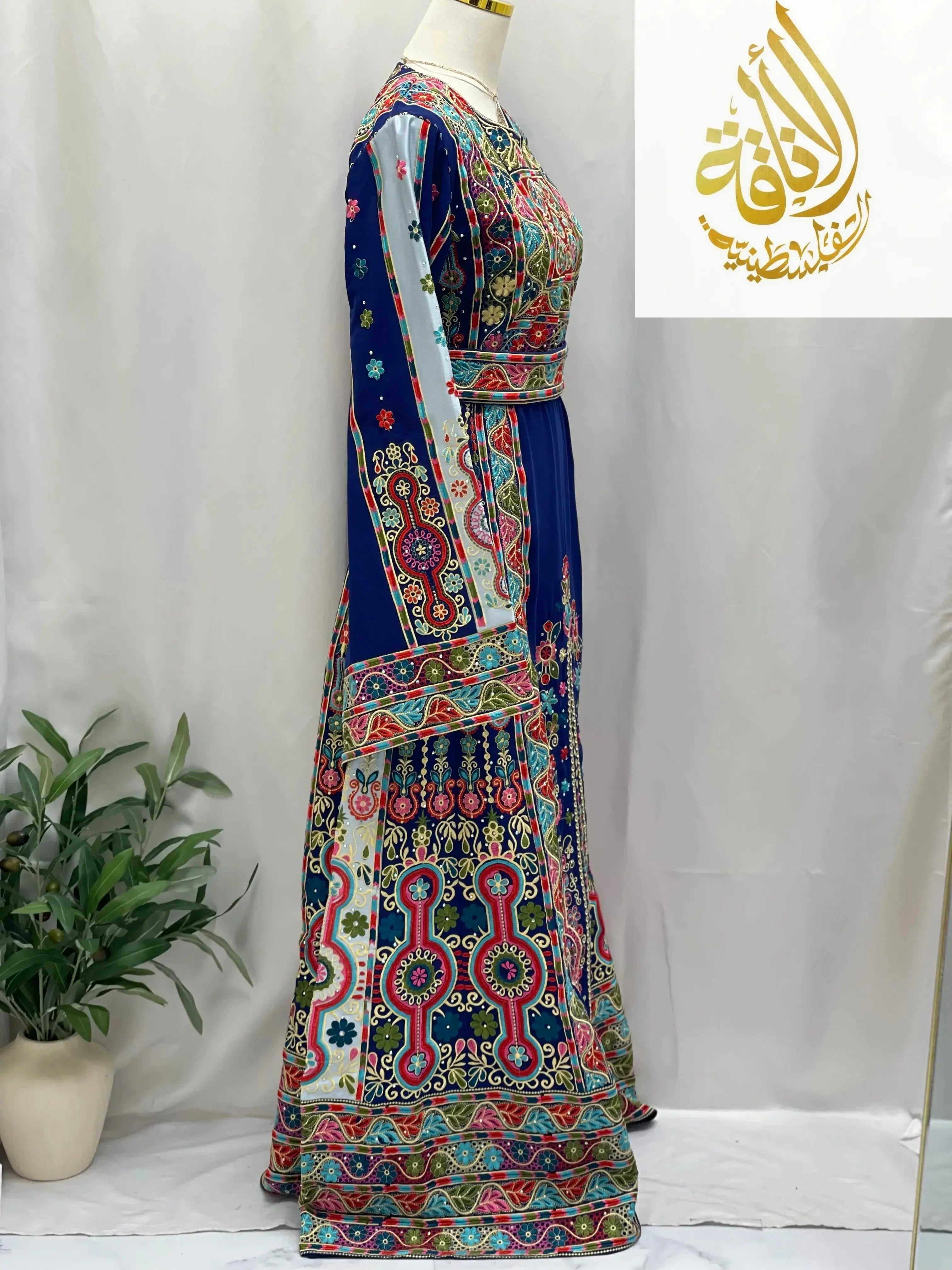 Royal blue embroidered thoub by Palestinian Elegance with detailed multicolor embroidery and long sleeves