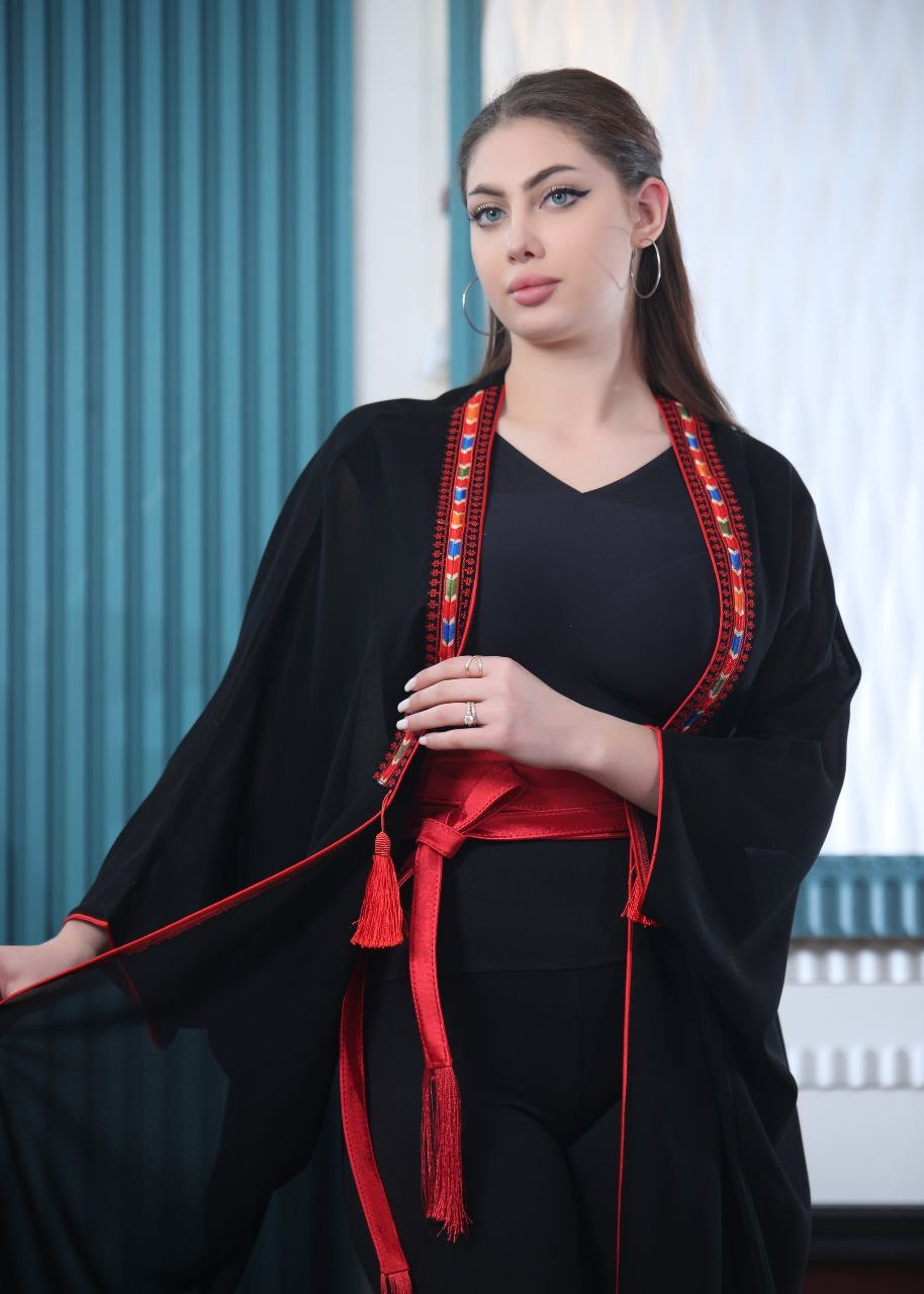 Palestinian Elegance embroidered chiffon cardigan in black with red detailing worn by a woman