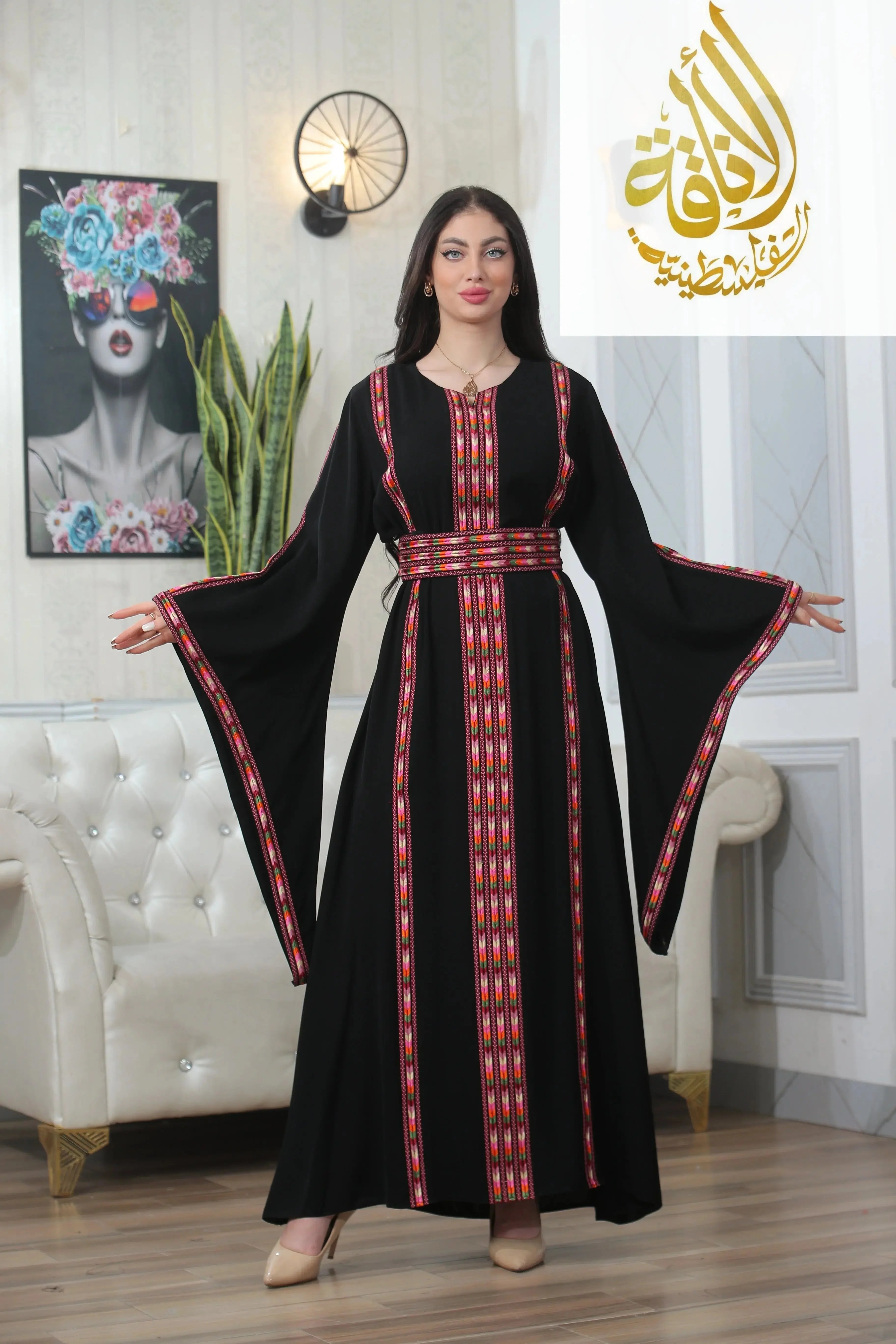 Woman wearing a black Salam Manjal Embroidered Thoub with red and white traditional embroidery and wide sleeves