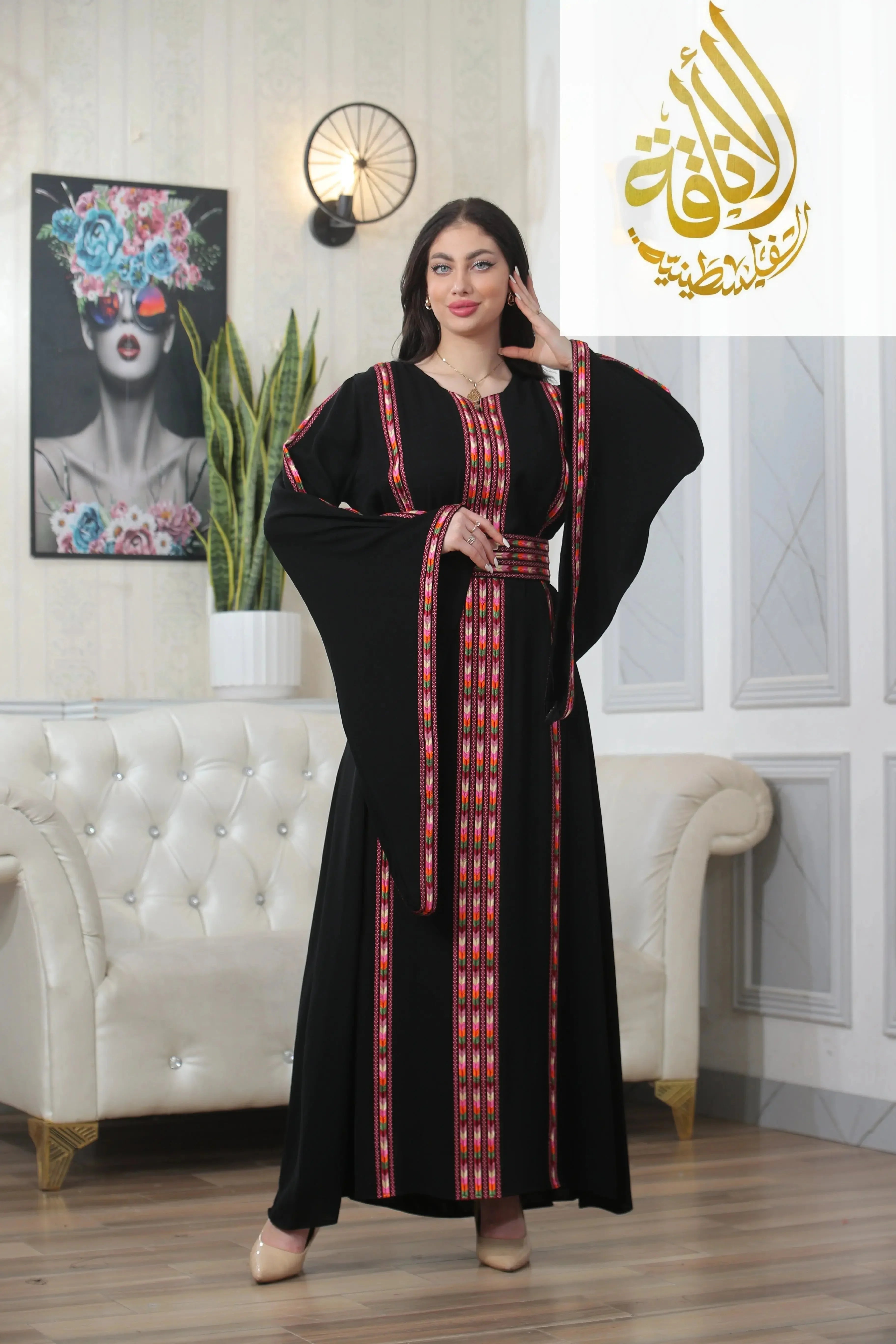 Palestinian Elegance Salam Manjal Embroidered Thoub in black with red and pink geometric embroidery 