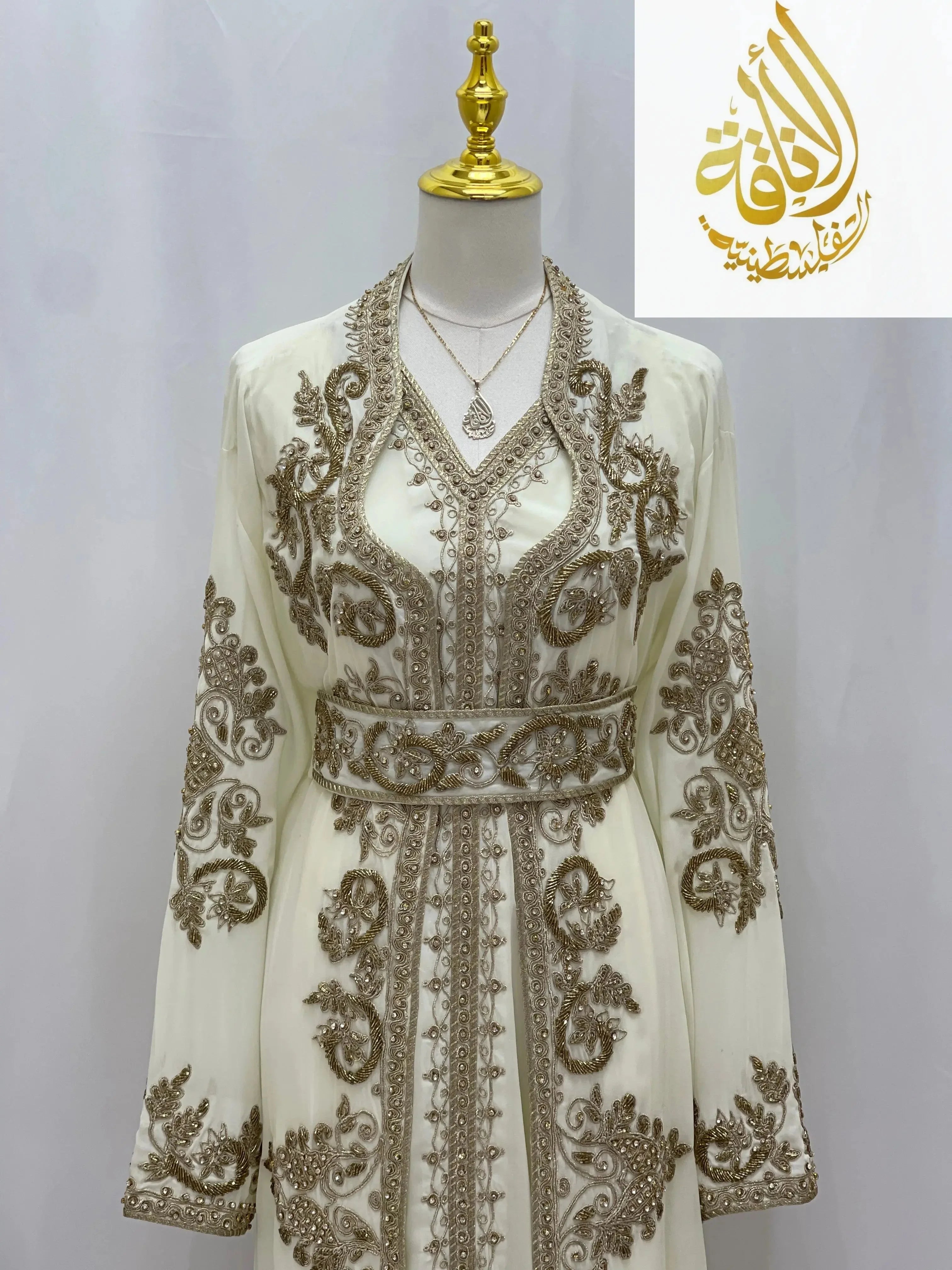 Palestinian Elegance Moroccan Style Kaftan in white with intricate gold embroidery and matching belt