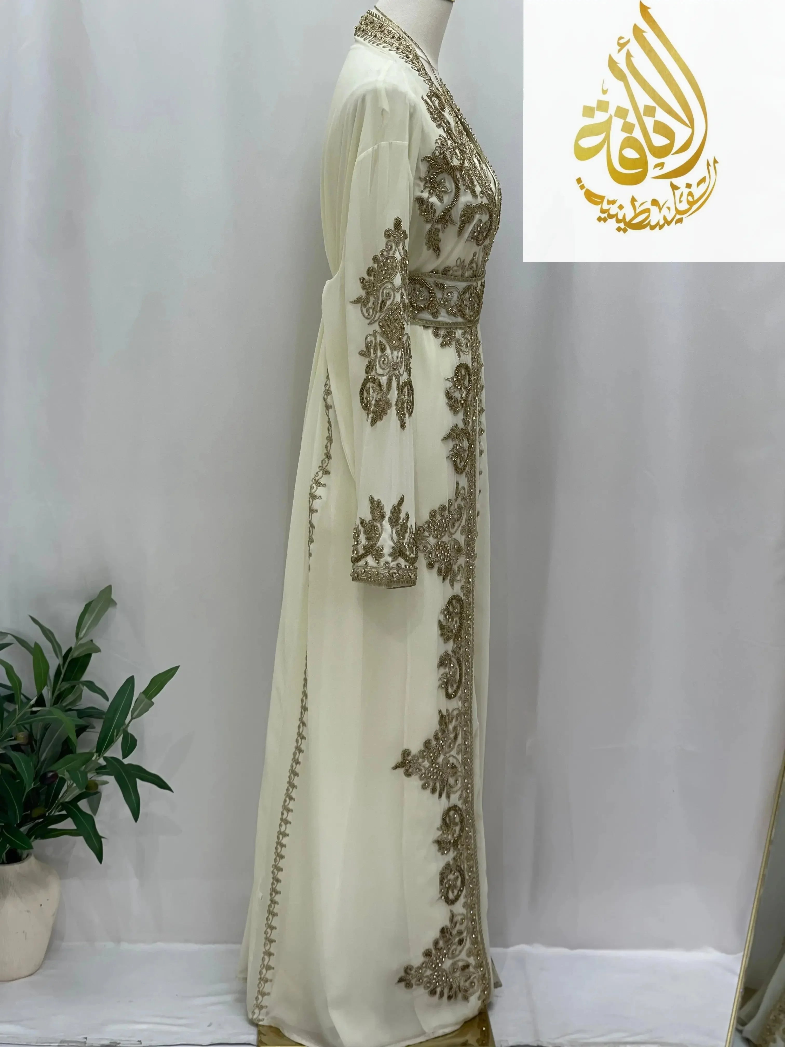 Palestinian Elegance Moroccan Style Kaftan in white with intricate gold embroidery on sleeves and front