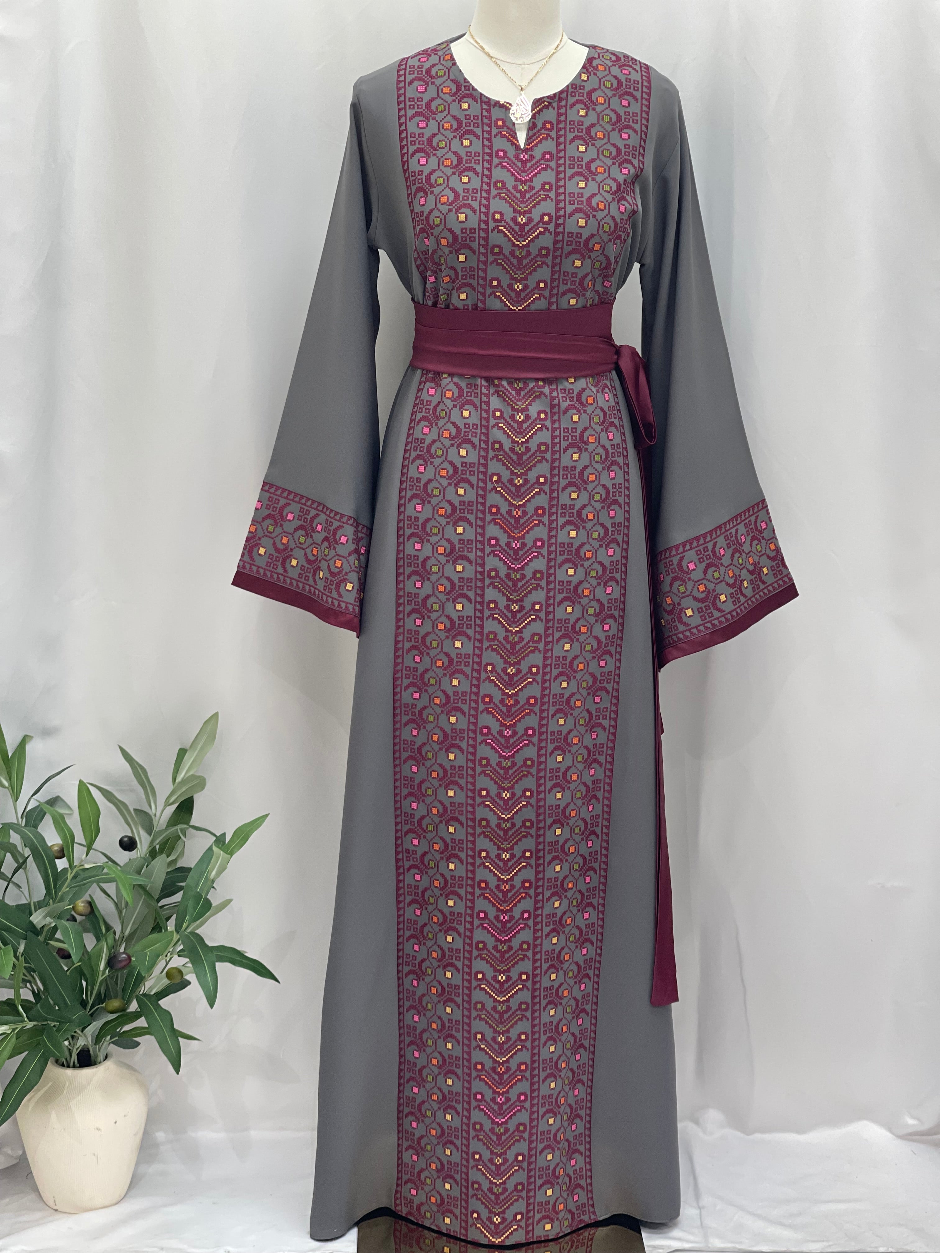 Palestinian Elegance Embroiderd Thobe With Belt in gray with detailed pink embroidery on front and sleeves