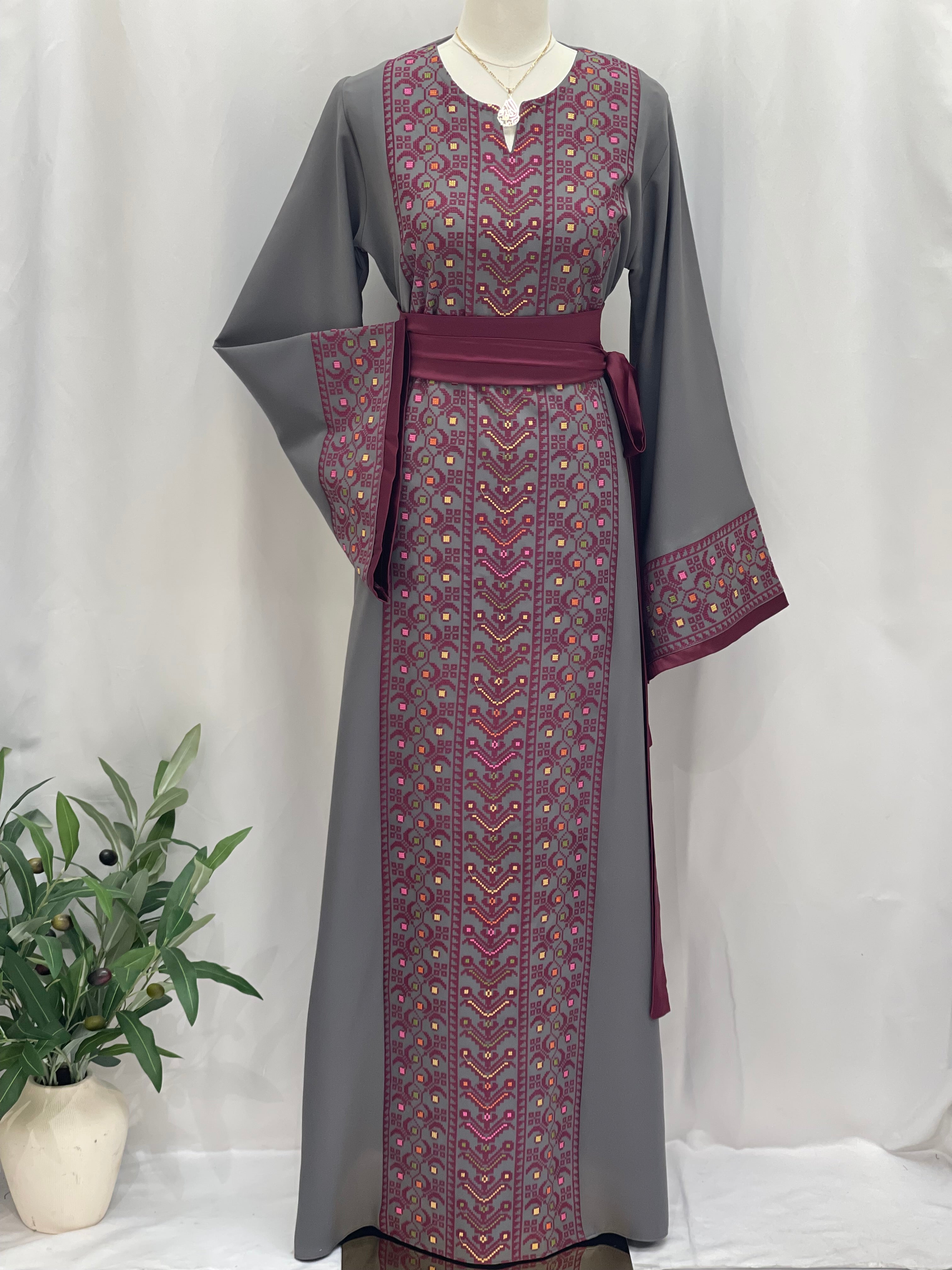 Palestinian Elegance Embroiderd Thobe With Belt in gray featuring detailed purple embroidery on front and sleeves