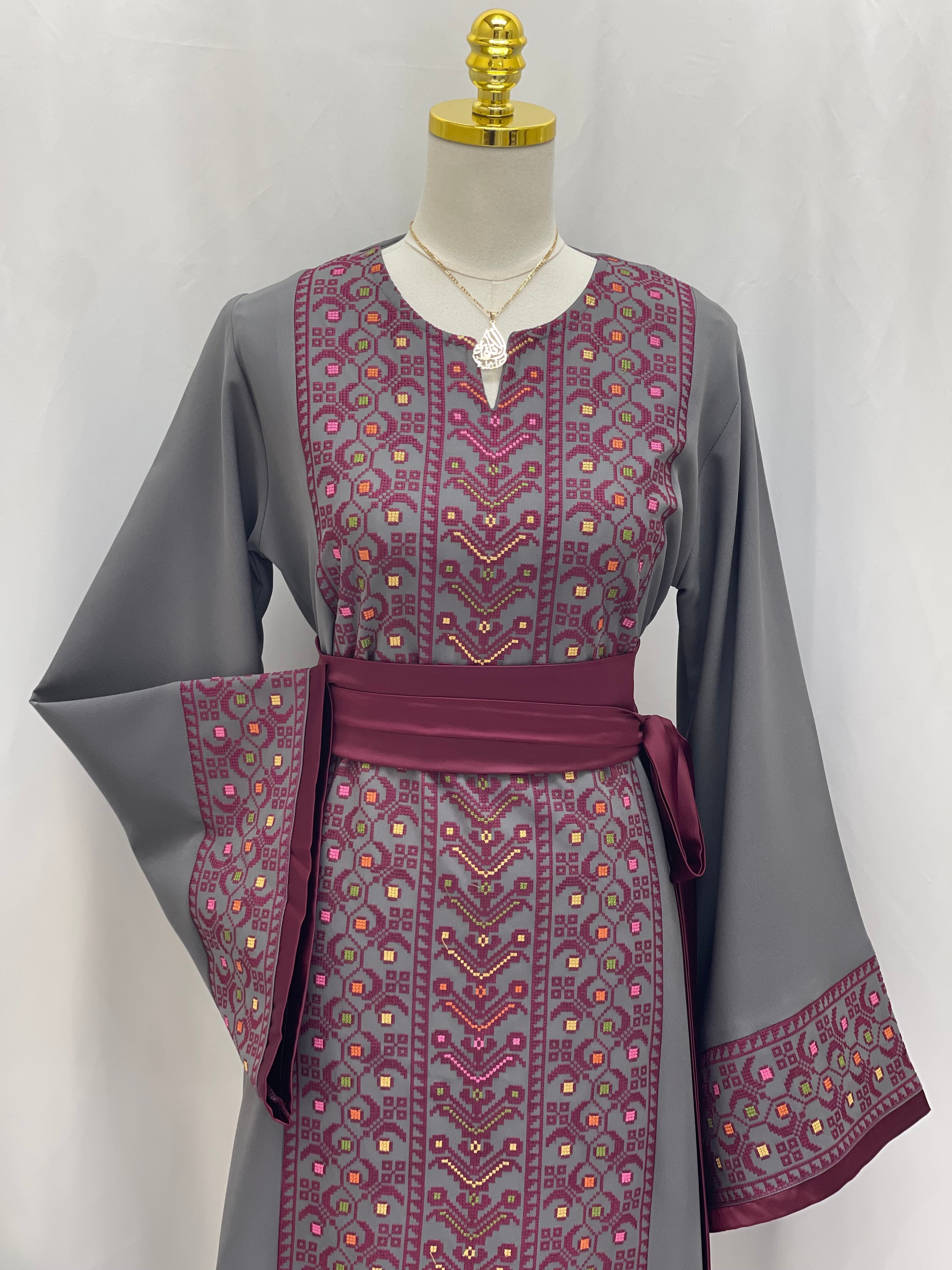 Palestinian Elegance Embroiderd Thobe With Belt in gray and purple detailed with intricate embroidery on front and sleeves
