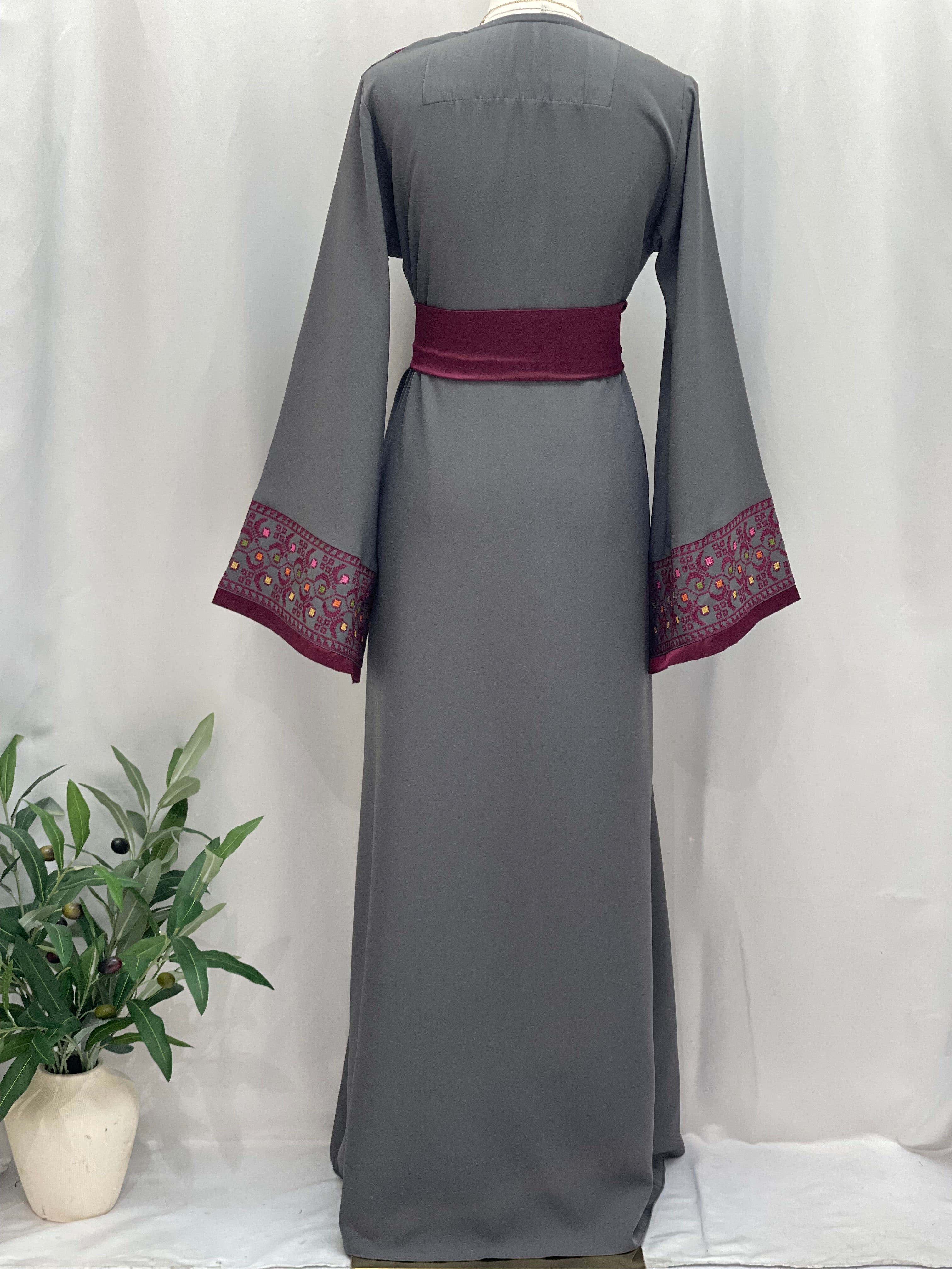 Back view of Embroiderd Thobe With Belt in gray with maroon embroidered cuffs and matching belt by Palestinian Elegance