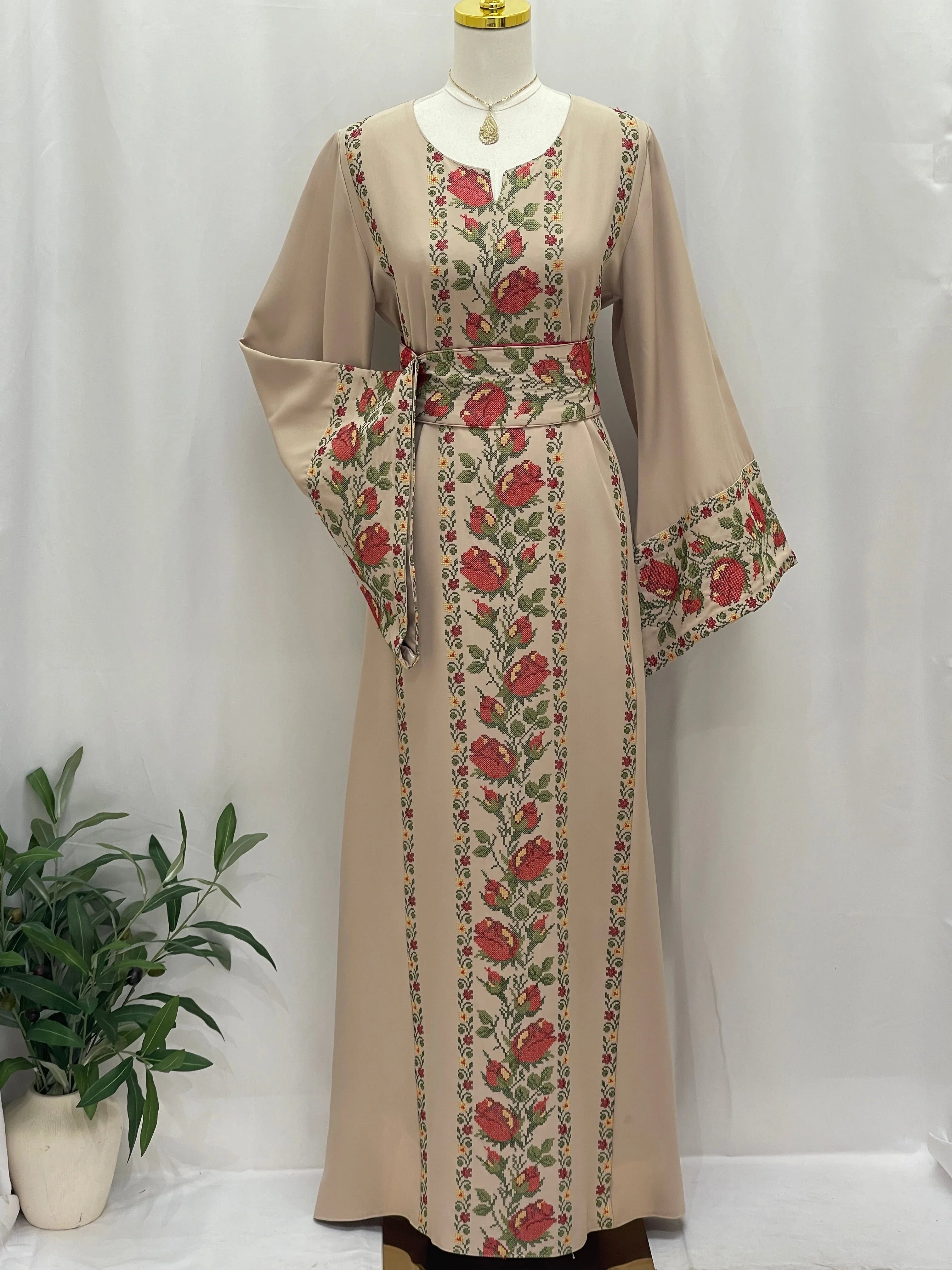 Elegant Shaqaeq Embroidered Thobe with floral patterns and a cinched waist for traditional style