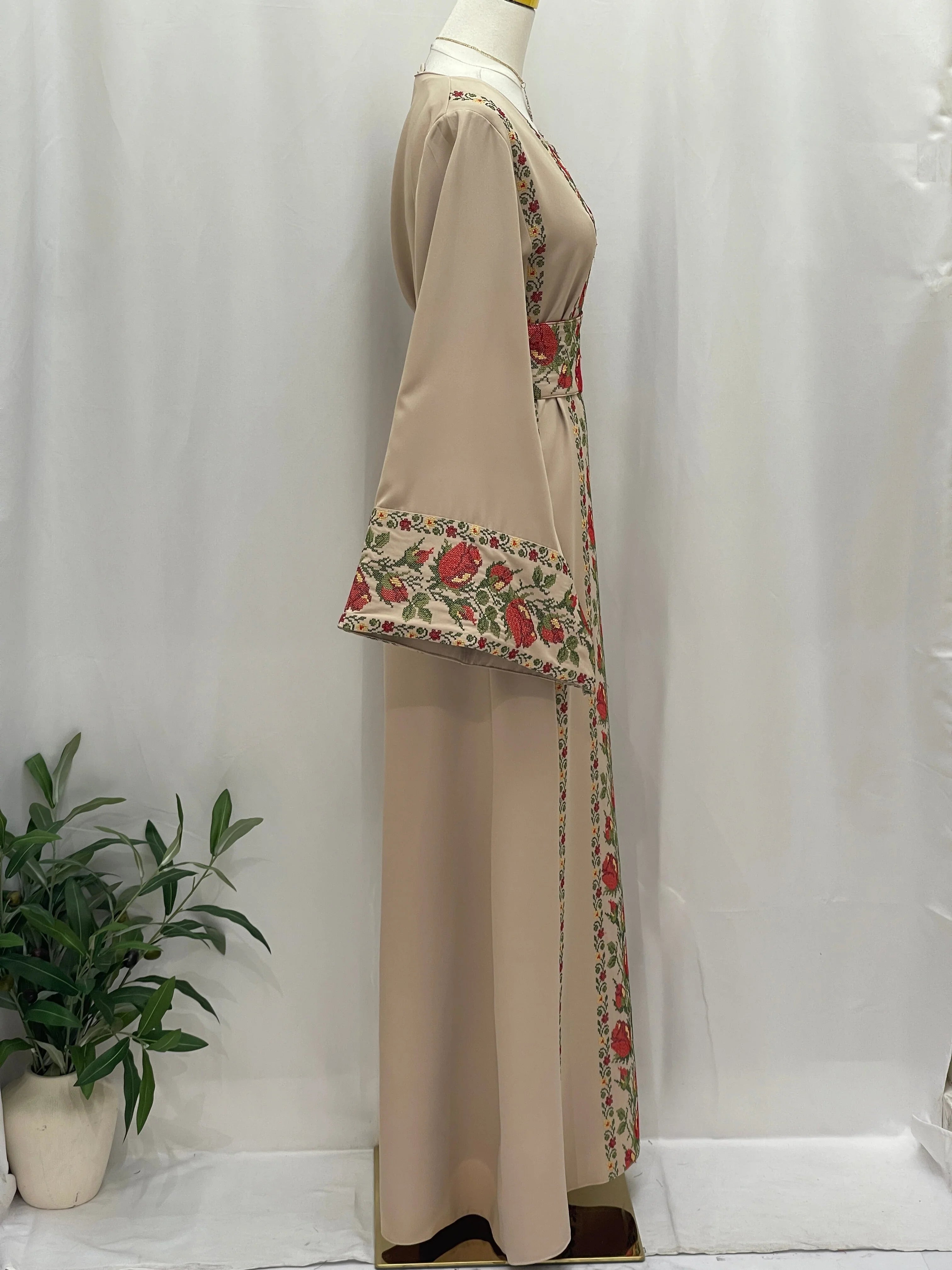Side view of Shaqaeq Embroidered Thobe with vibrant floral embroidery and flowing sleeves