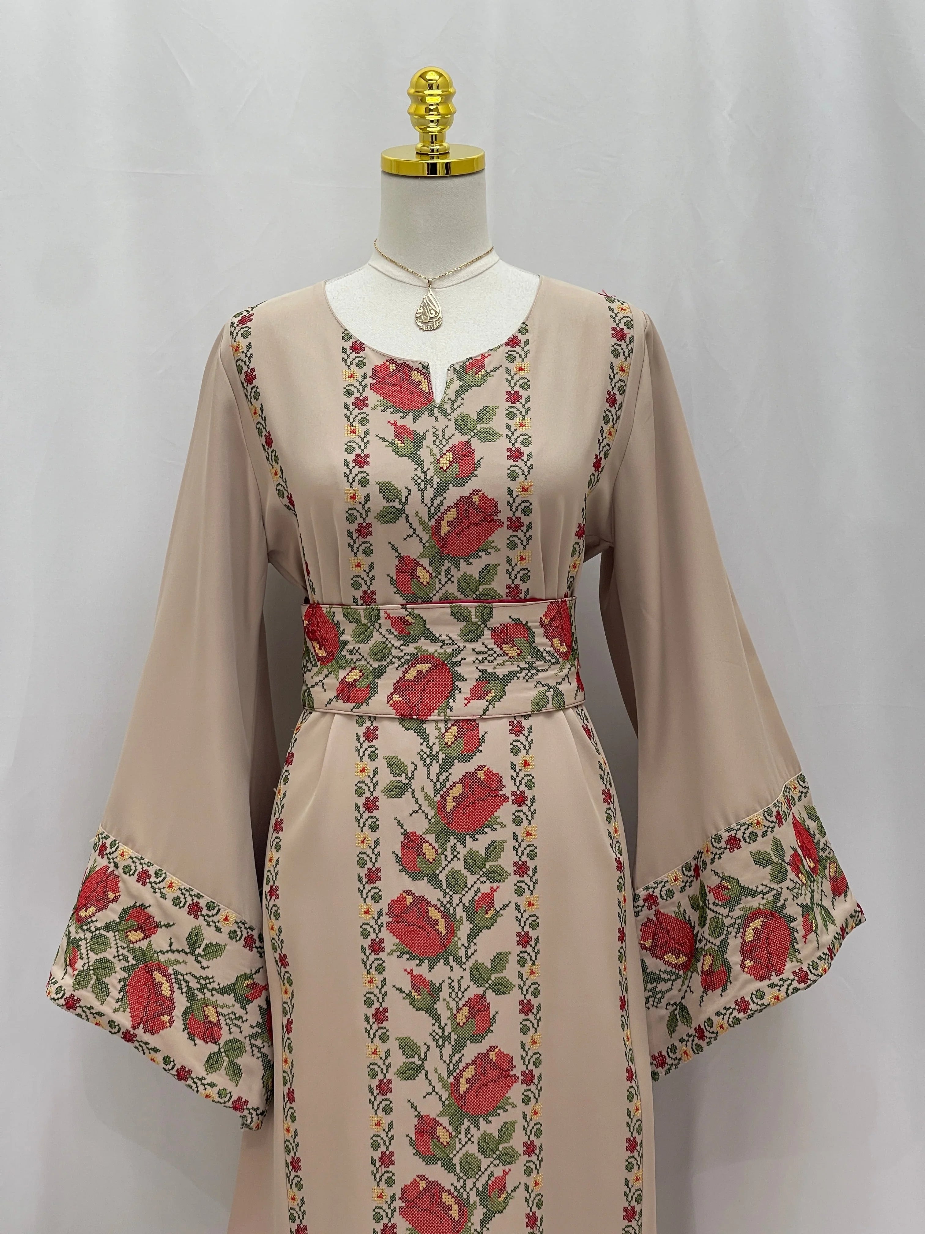 Shaqaeq Embroidered Thobe featuring elegant floral designs on a beige background