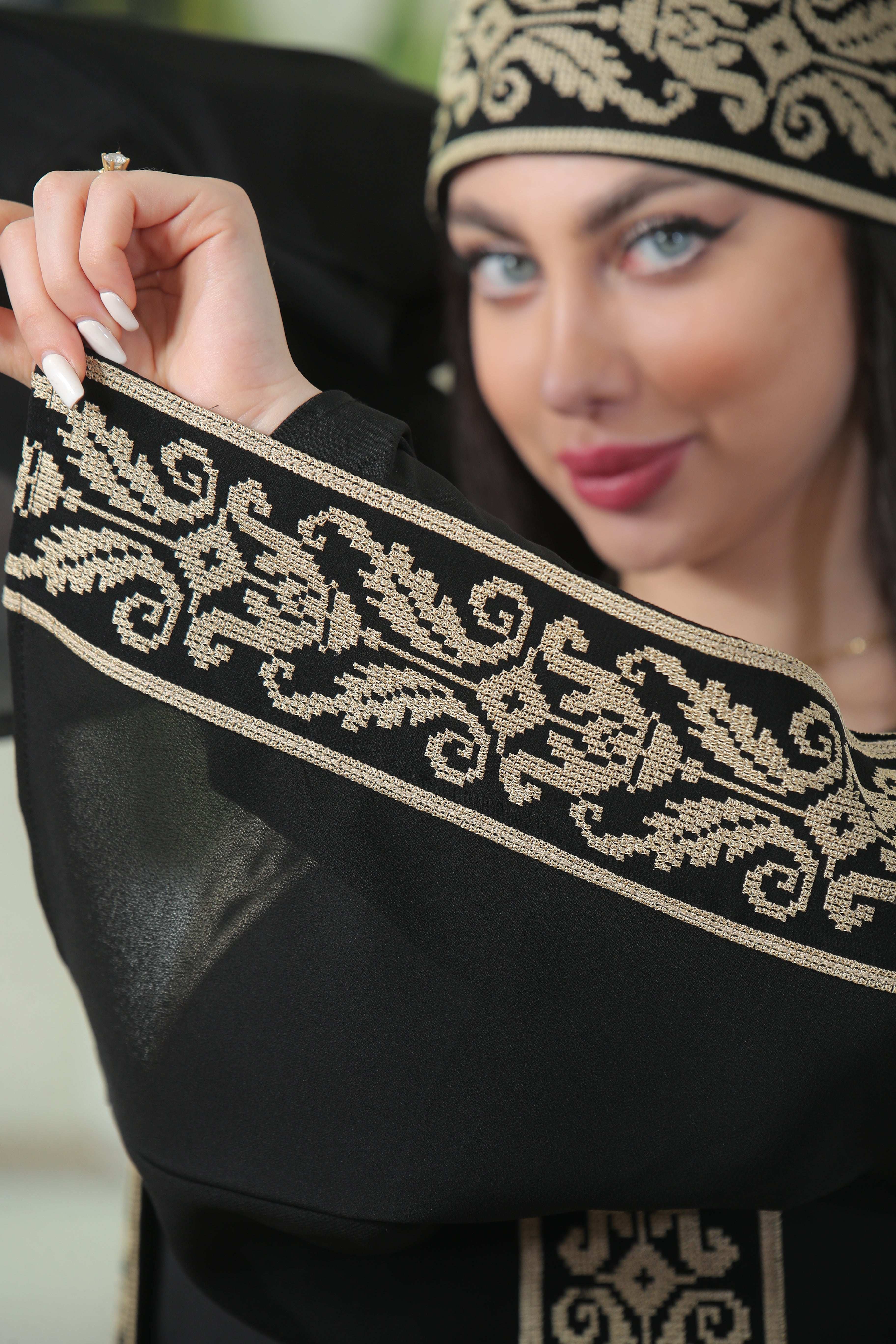 Close-up of black Shereen Embroidered Bisht Abaya with intricate beige embroidery on sleeve by Palestinian Elegance