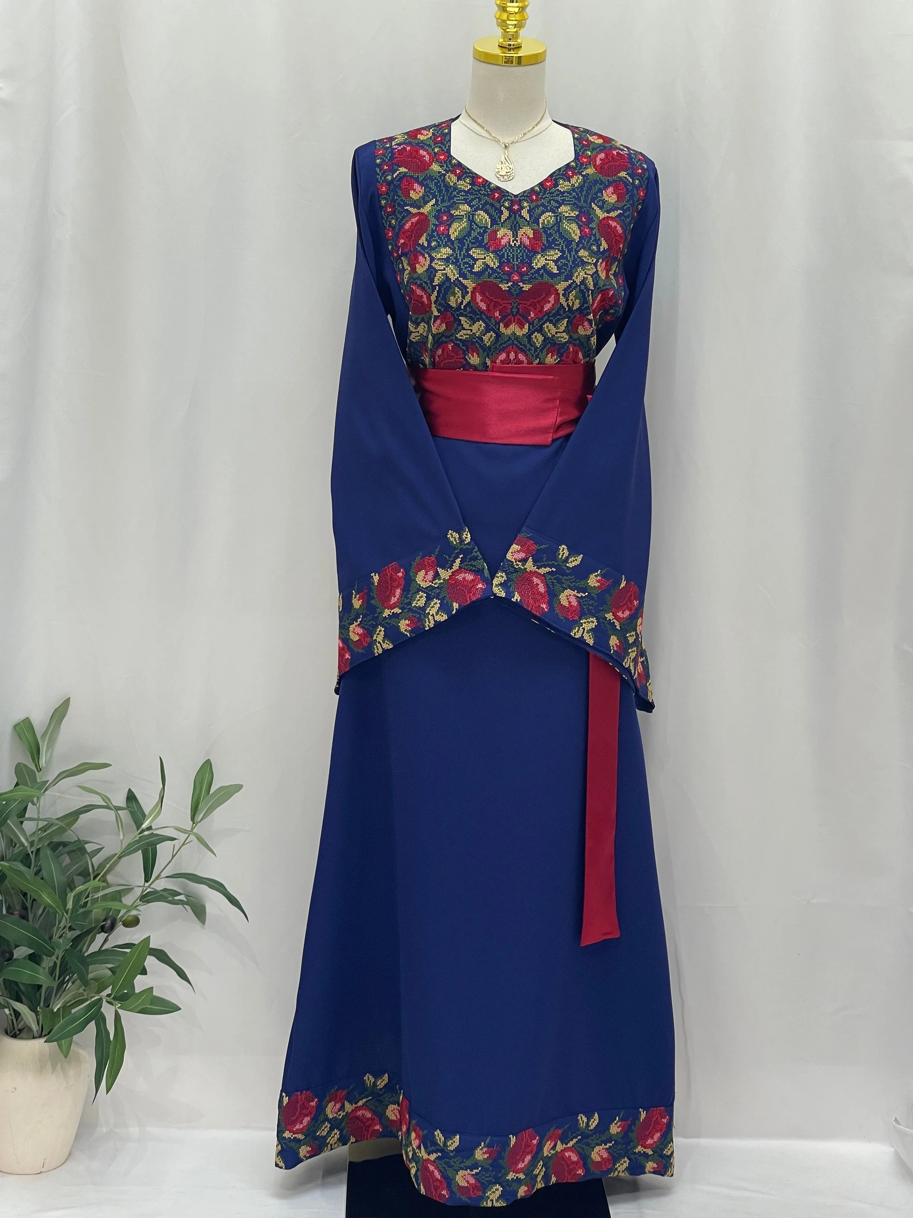 Palestinian Elegance Blossom Royal Blue Thobe embroidered floral bodice and hem with red sash for formal wear