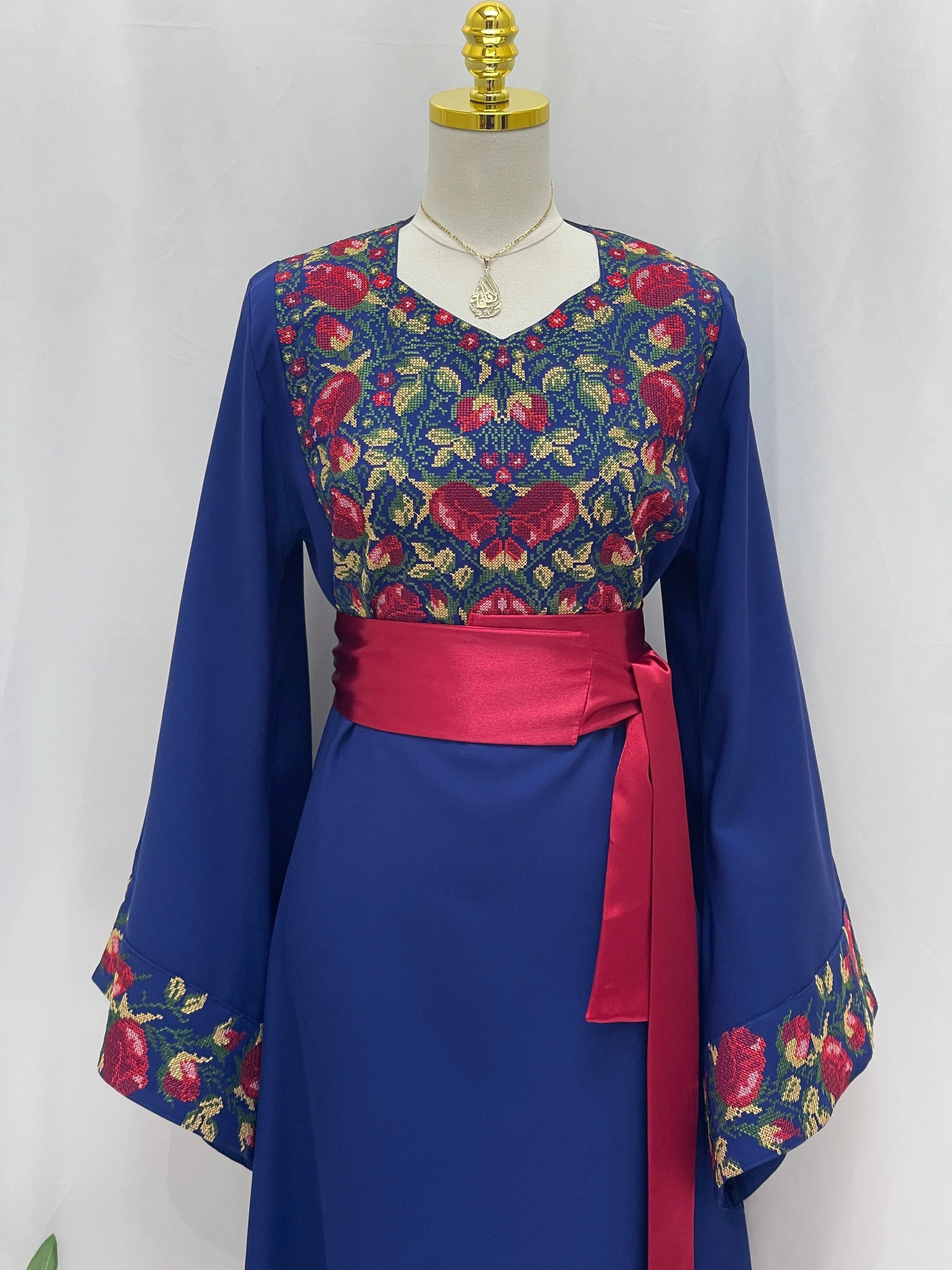 Blossom Royal Blue Thobe embroidered with red and gold floral chest and cuff patterns with red satin sash belt