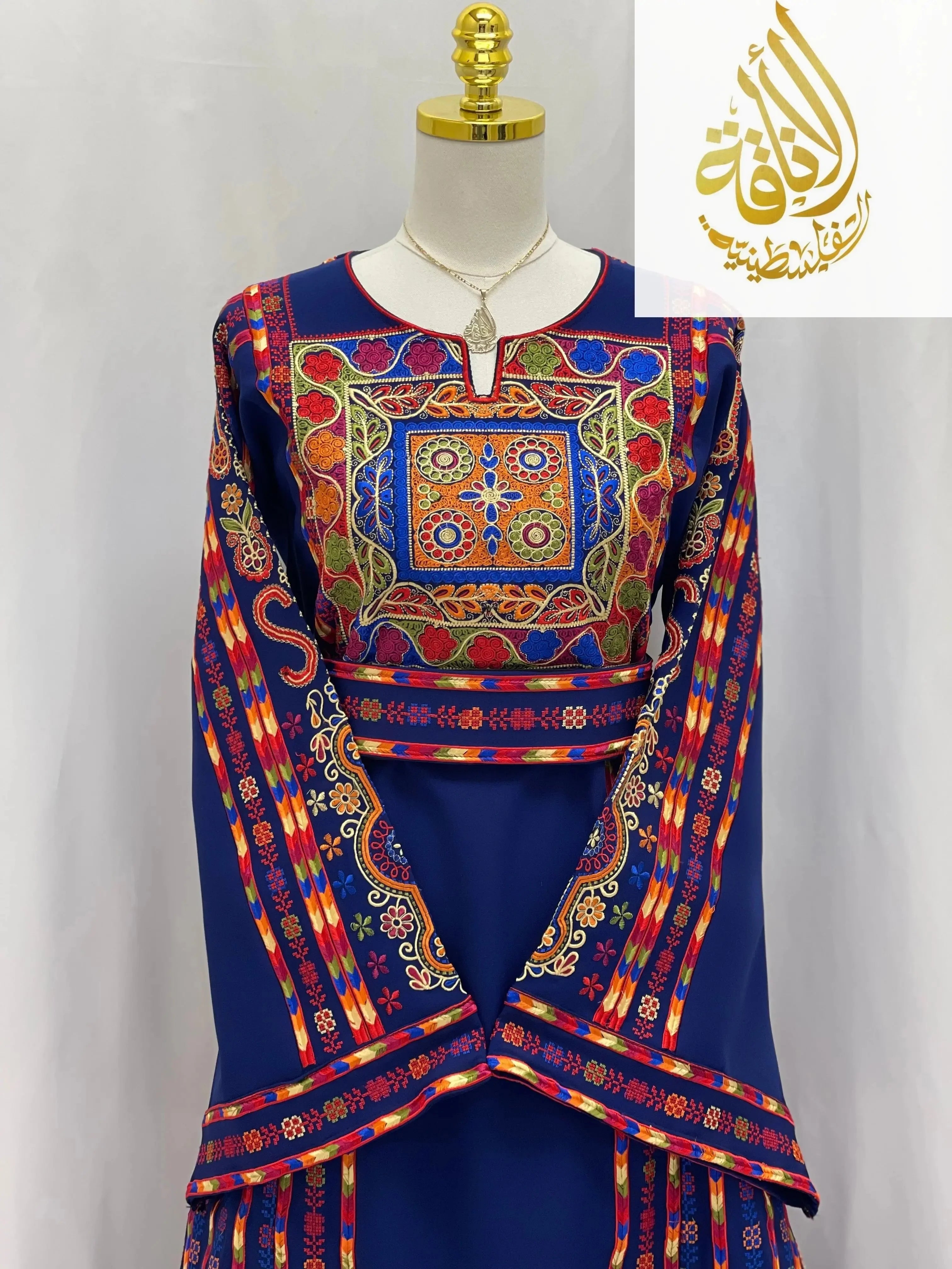 Embroidered Palestinian dress by Palestinian Elegance with vibrant traditional colorful embroidery on navy fabric