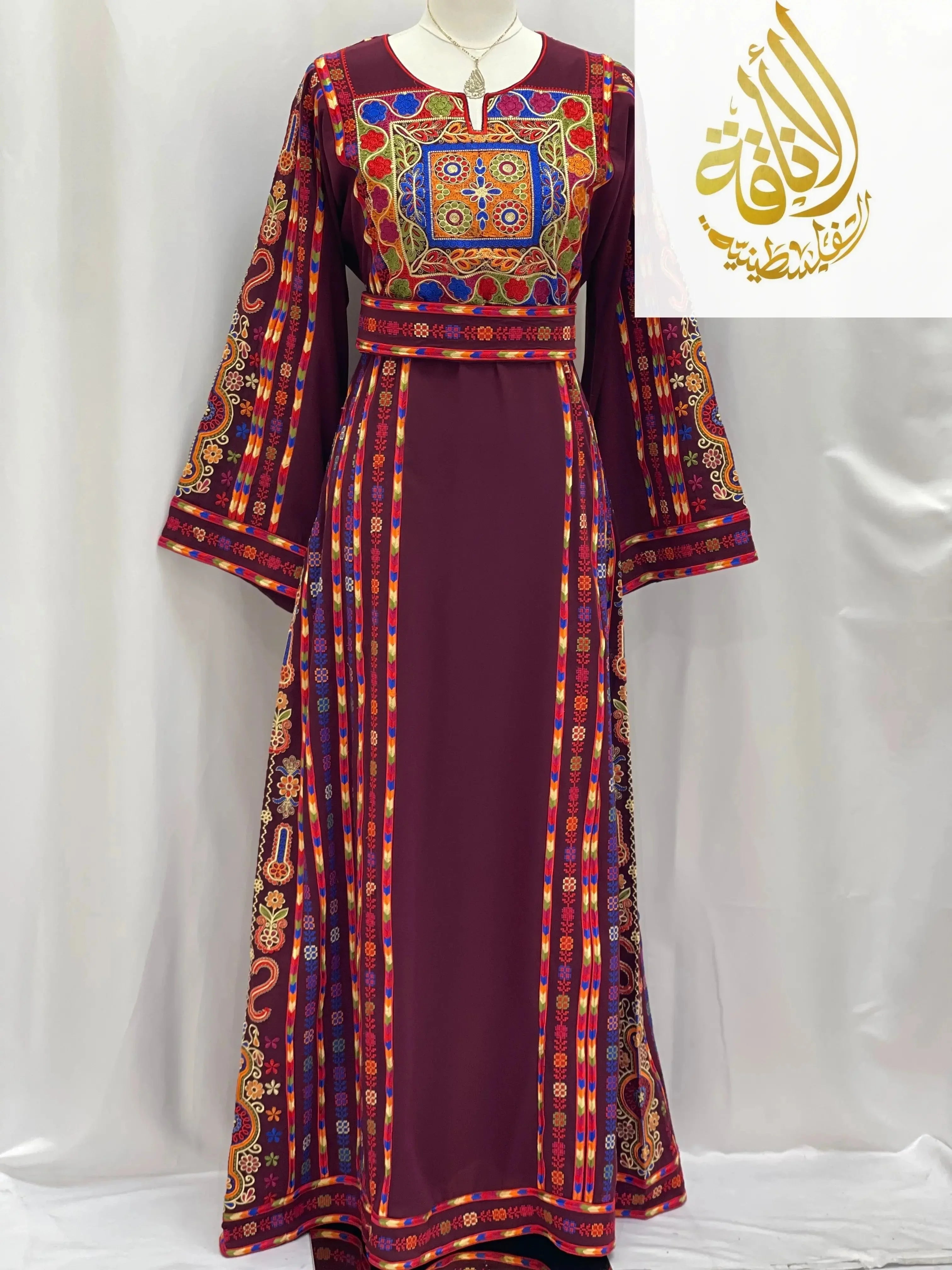Embroidered Palestinian dress with vibrant multicolor patterns and detailed traditional embroidery by Palestinian Elegance