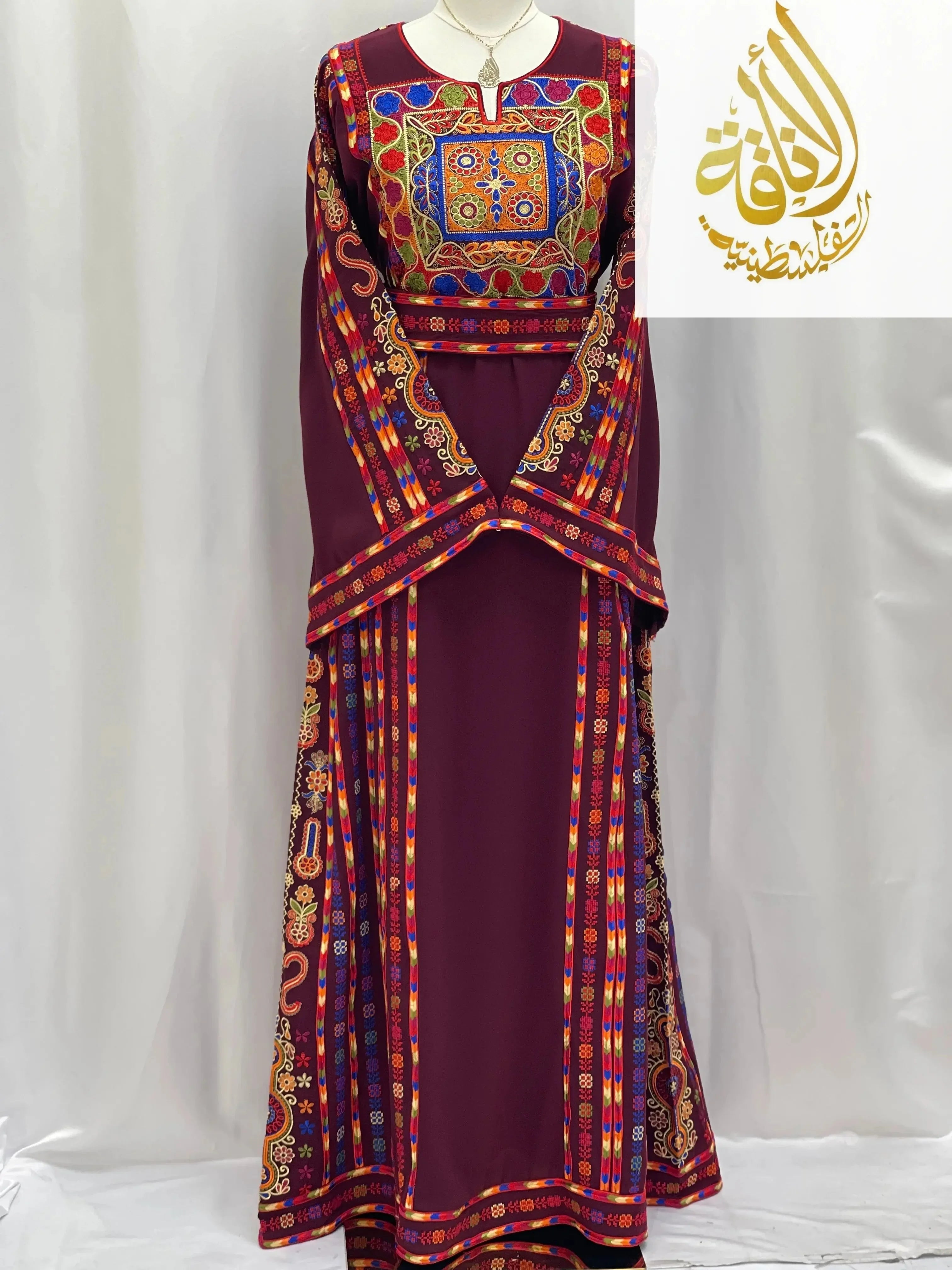 Embroidered Palestinian dress in deep maroon with colorful traditional embroidery by Palestinian Elegance