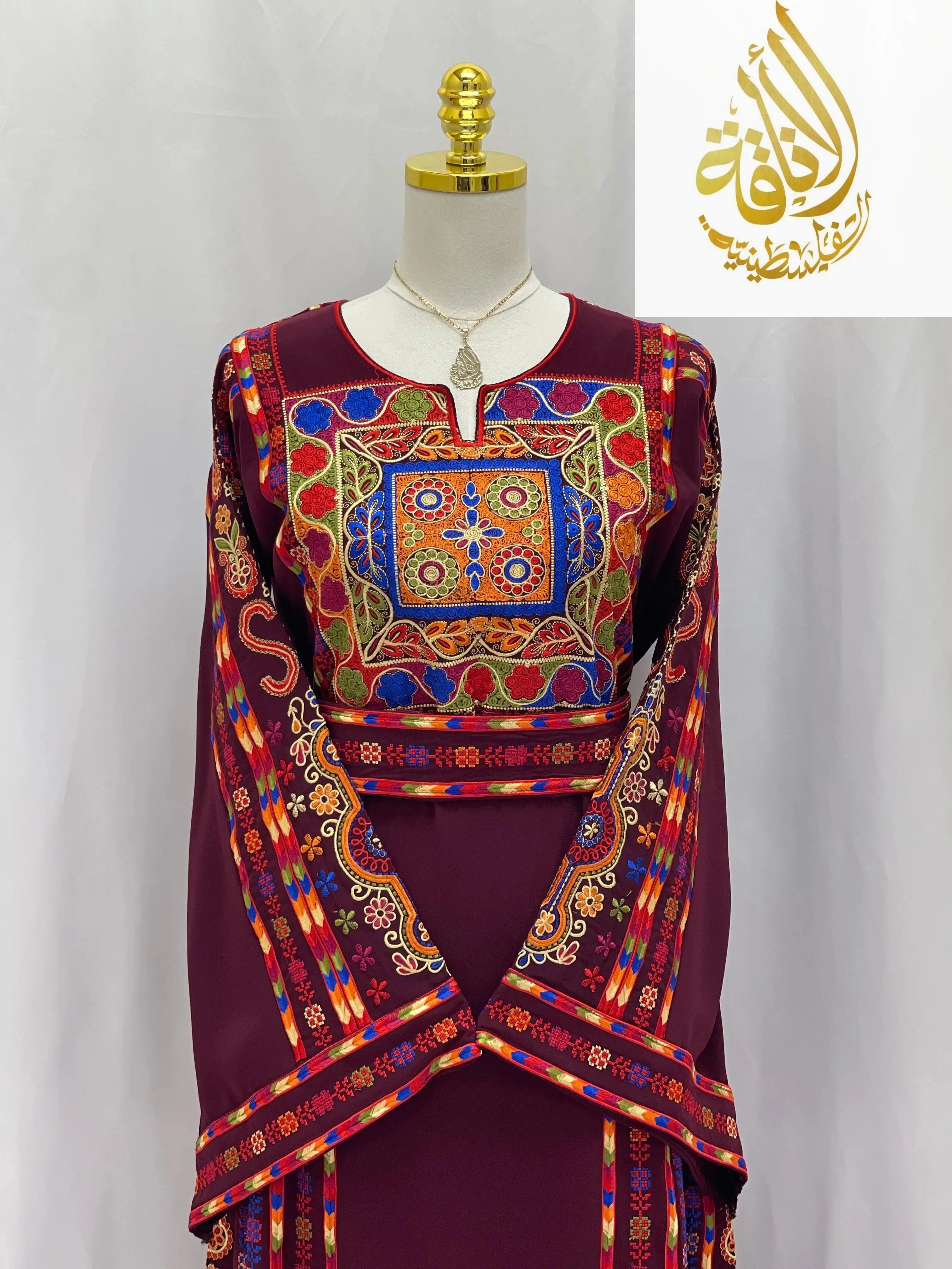 Richly detailed embroidered Palestinian dress with vibrant traditional patterns by Palestinian Elegance