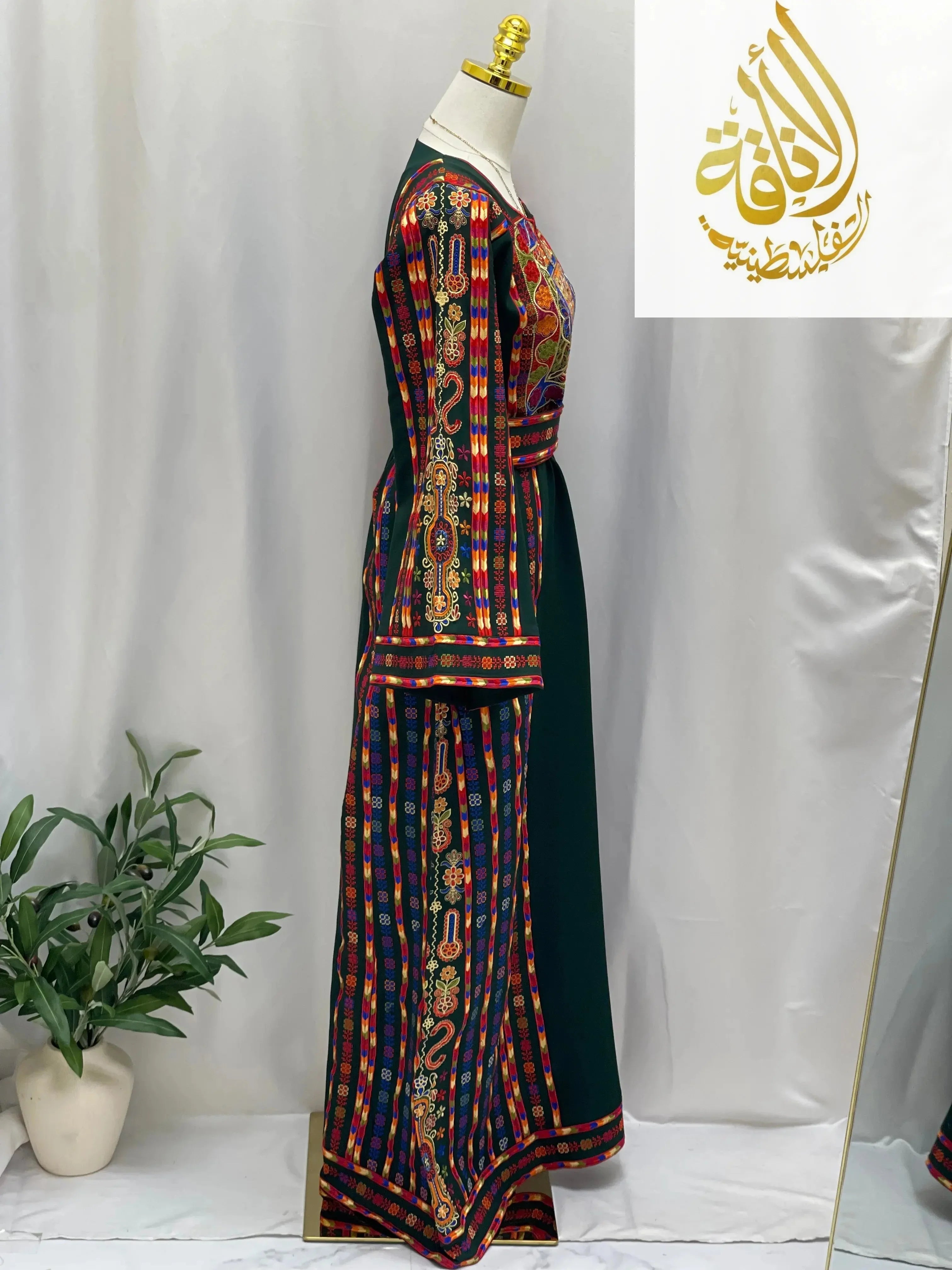 Side view of embroidered Palestinian dress with colorful traditional embroidery by Palestinian Elegance
