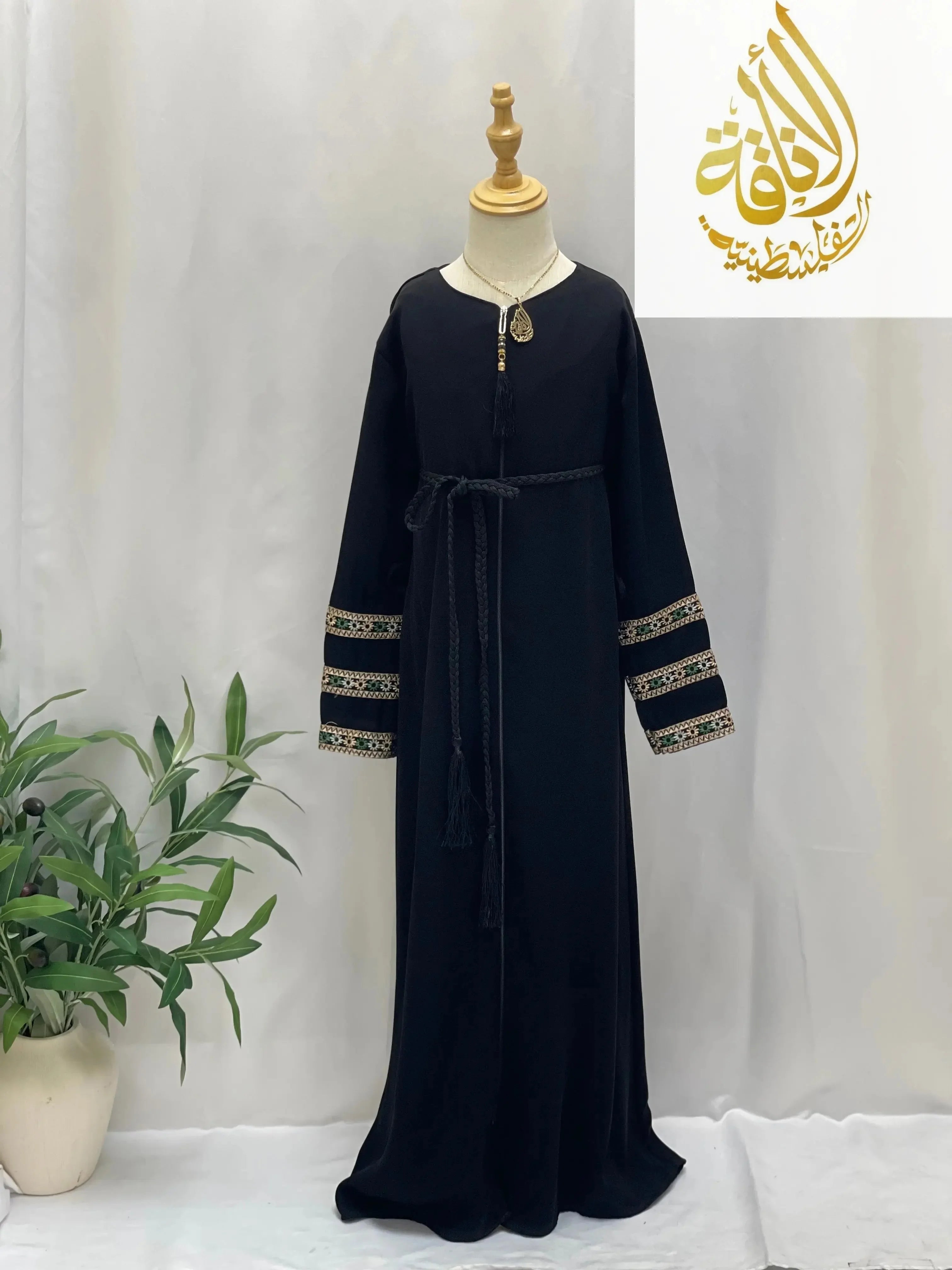 Black embroidered abaya for girls with detailed sleeve embroidery and waist tie by Palestinian Elegance