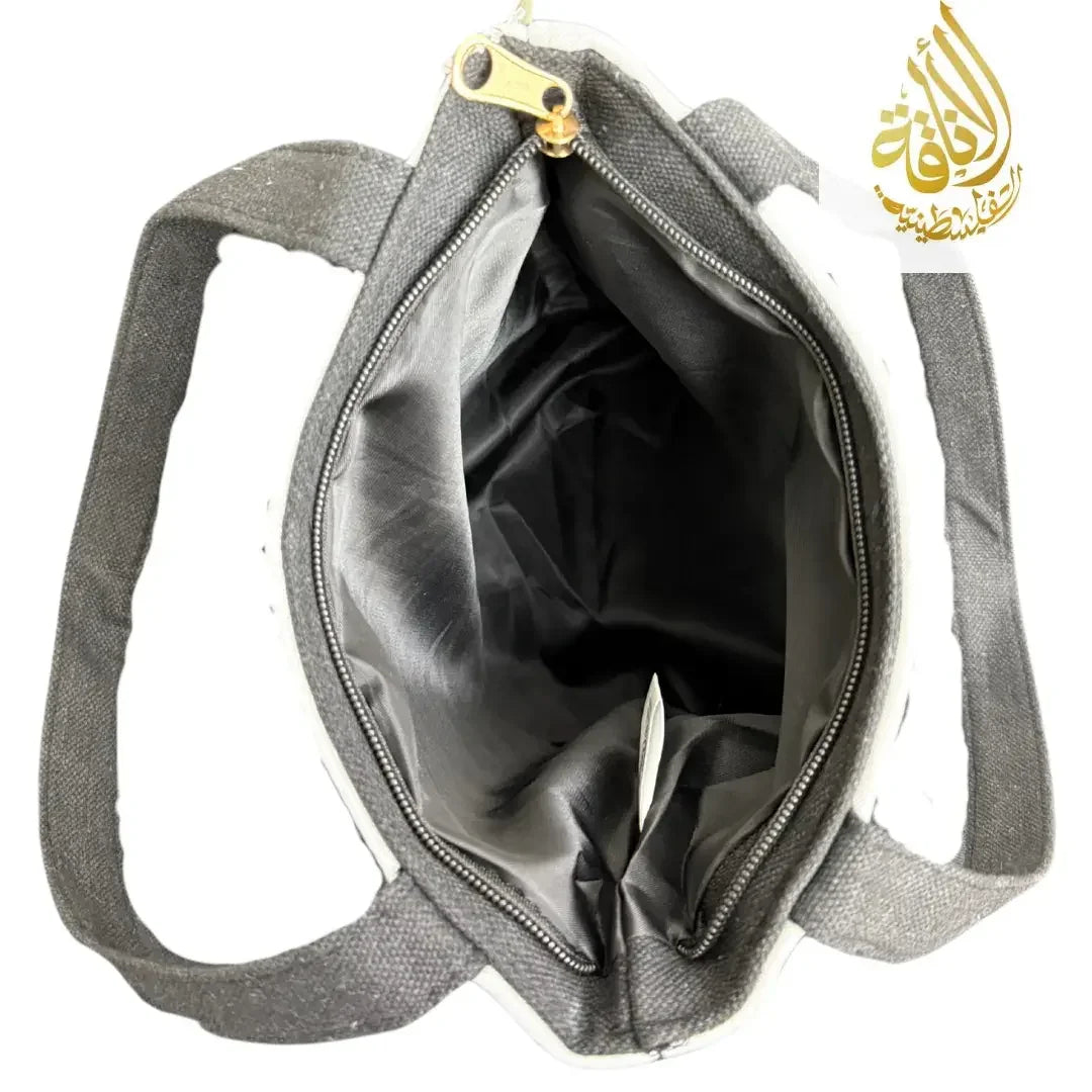 Open Palestinian embroidered tote bag showing spacious interior with black lining and sturdy handles