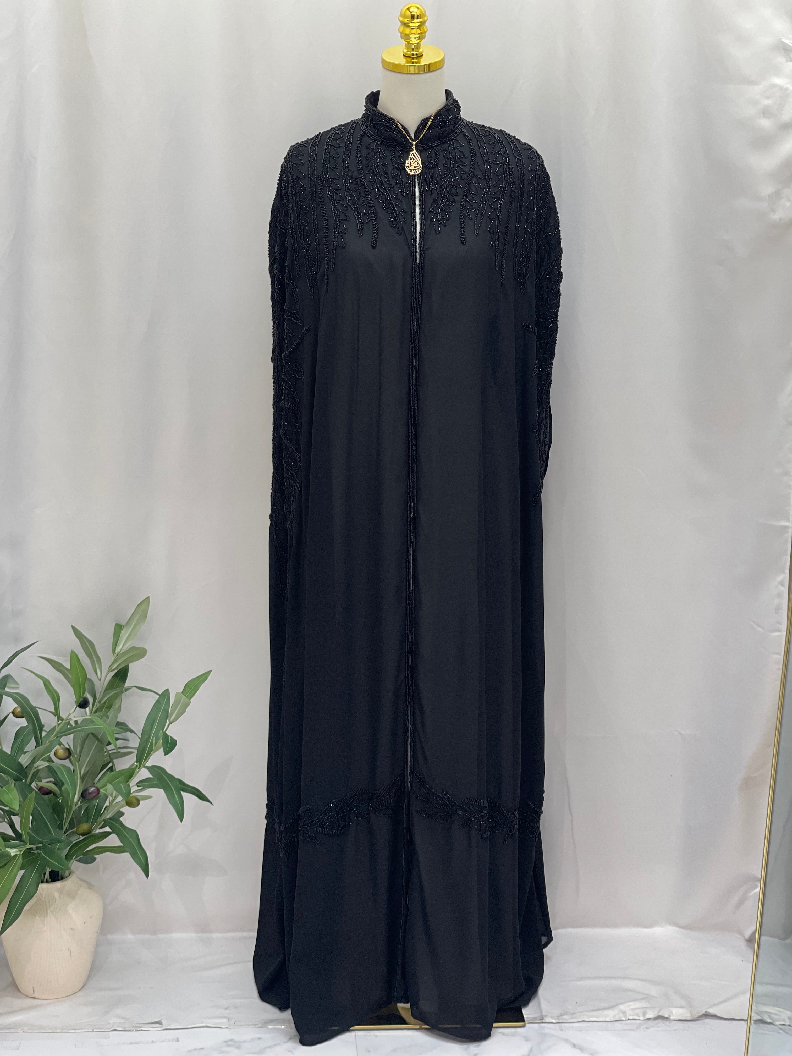 Black traditional embroidery cape with detailed stitching on shoulders and collar by Palestinian Elegance
