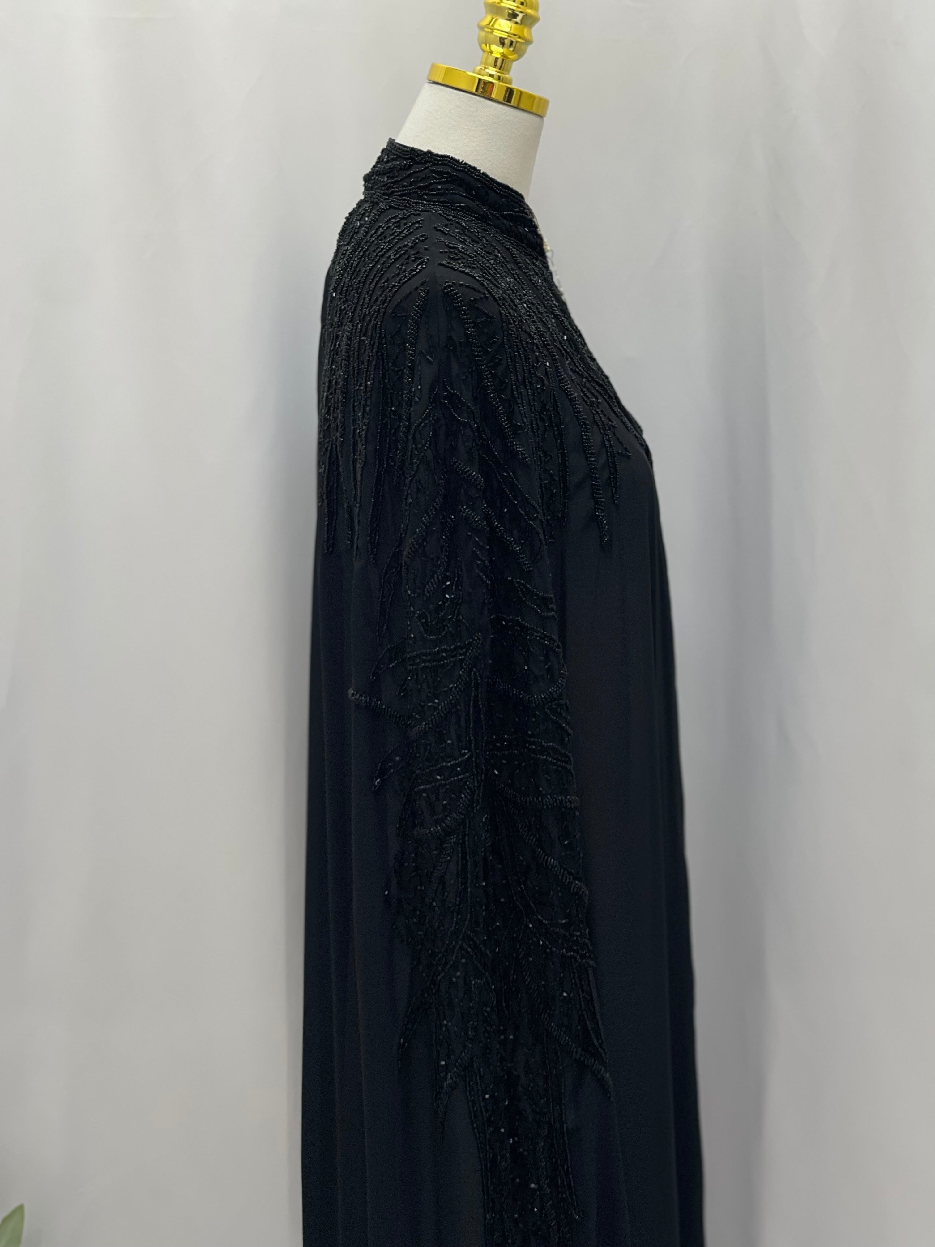 Black traditional embroidery cape with intricate beadwork detail by Palestinian Elegance