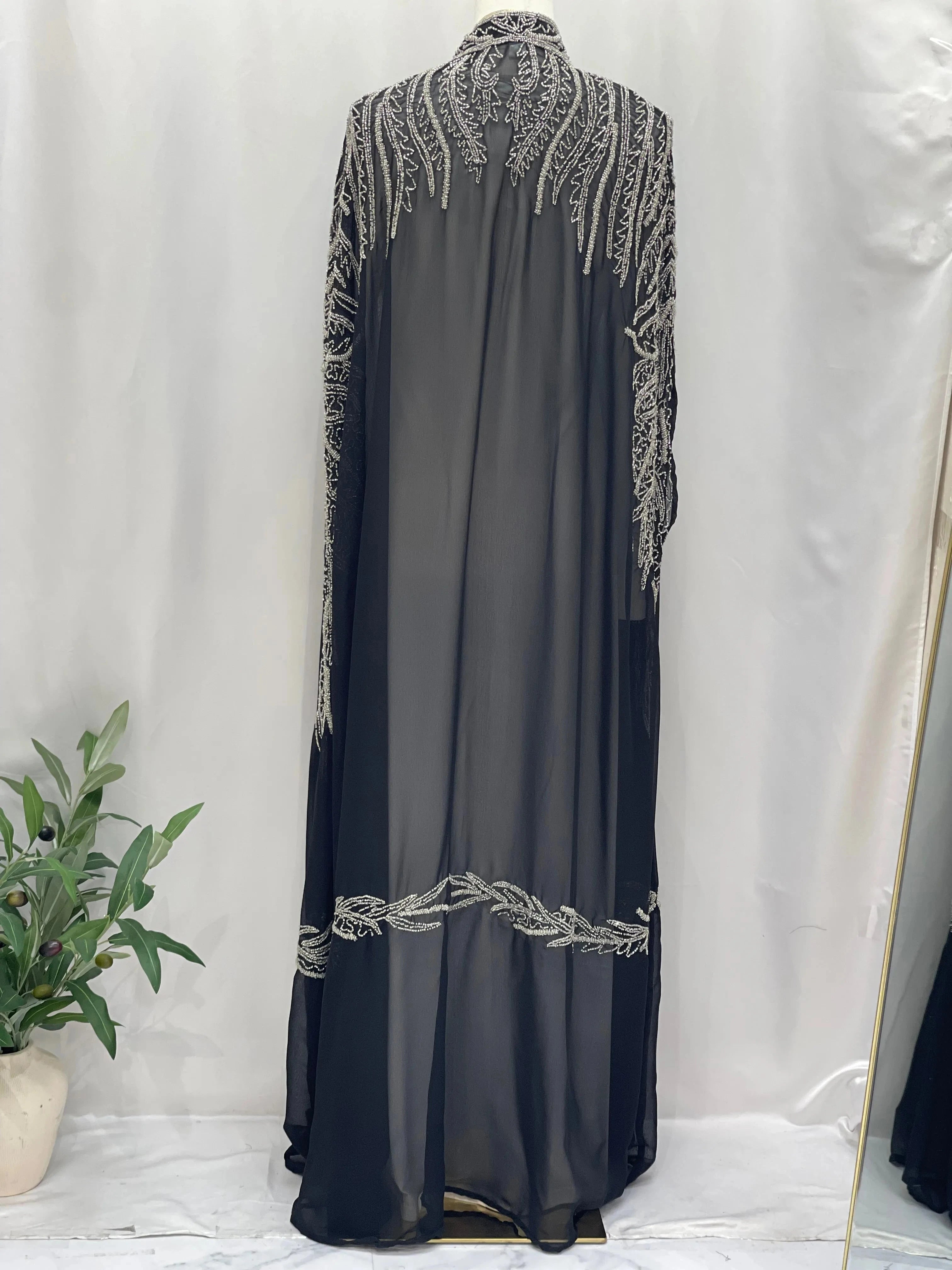 Black traditional embroidery cape with intricate silver patterns by Palestinian Elegance