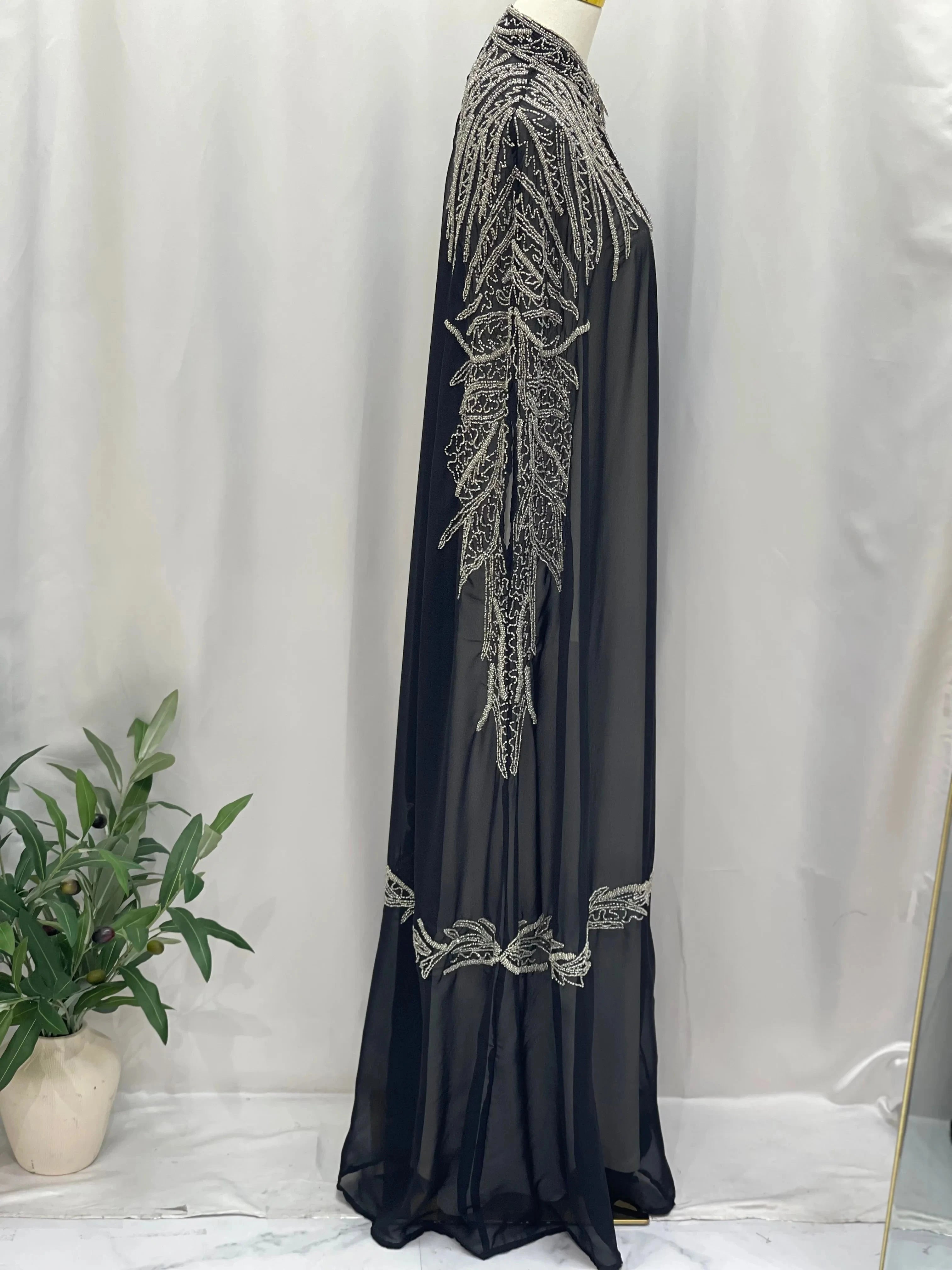 Black traditional embroidery cape with intricate silver embroidery on shoulders and sleeves by Palestinian Elegance