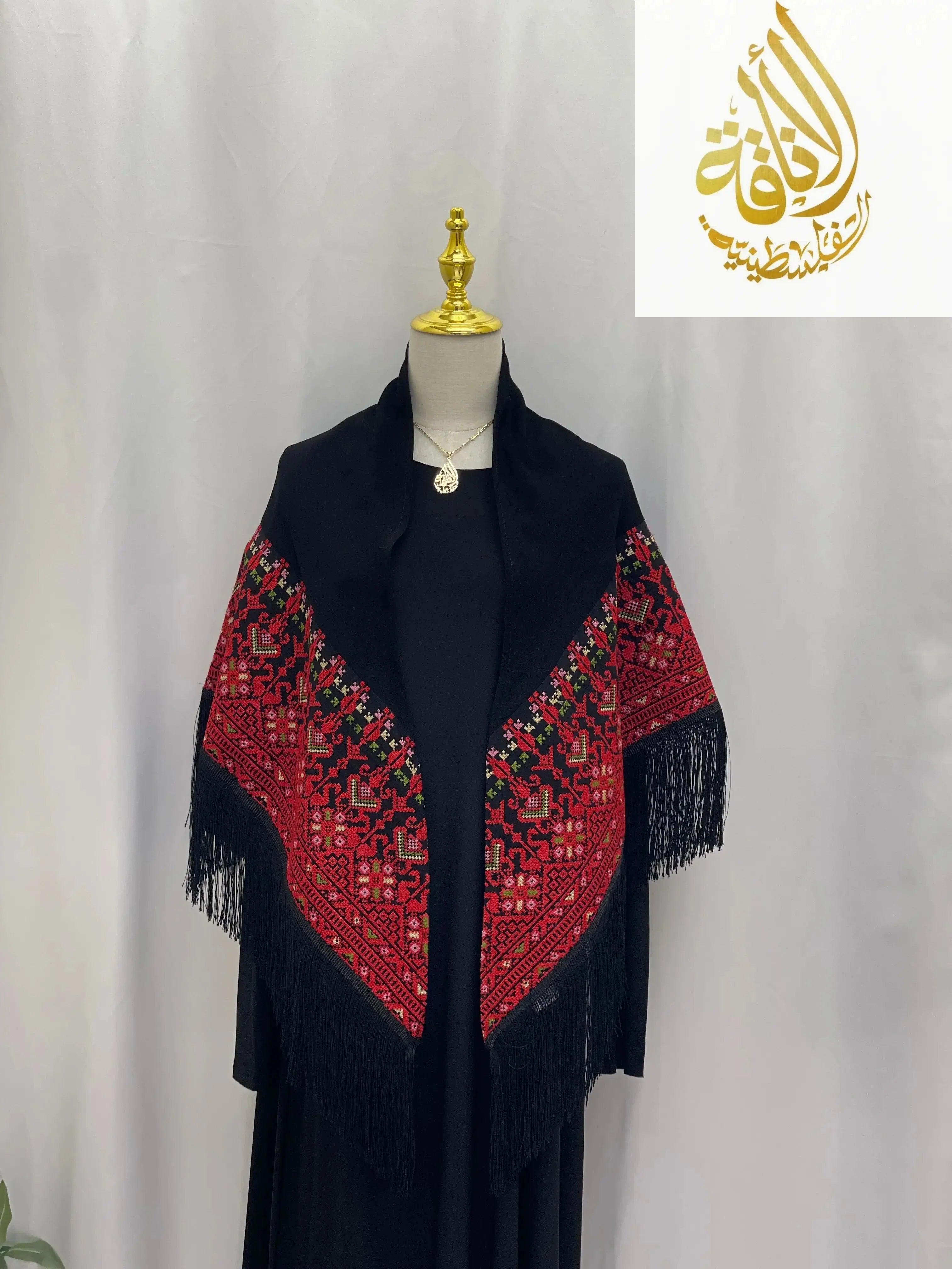 Palestinian embroidered shawl with intricate red and black geometric patterns and fringe detailing