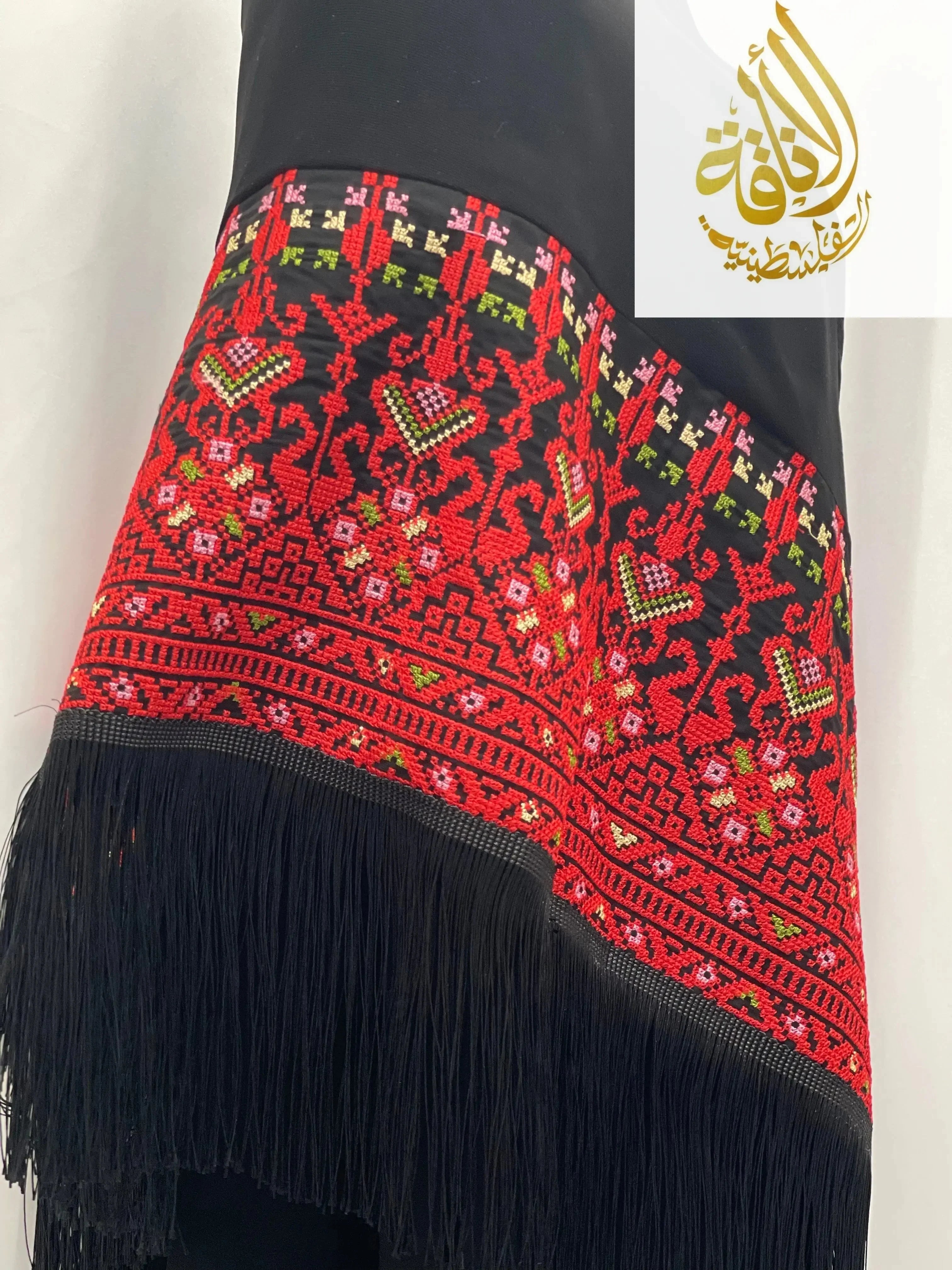 Palestinian Elegance black shawl with detailed red, green, and pink Palestinian embroidered shawl pattern and black fringe