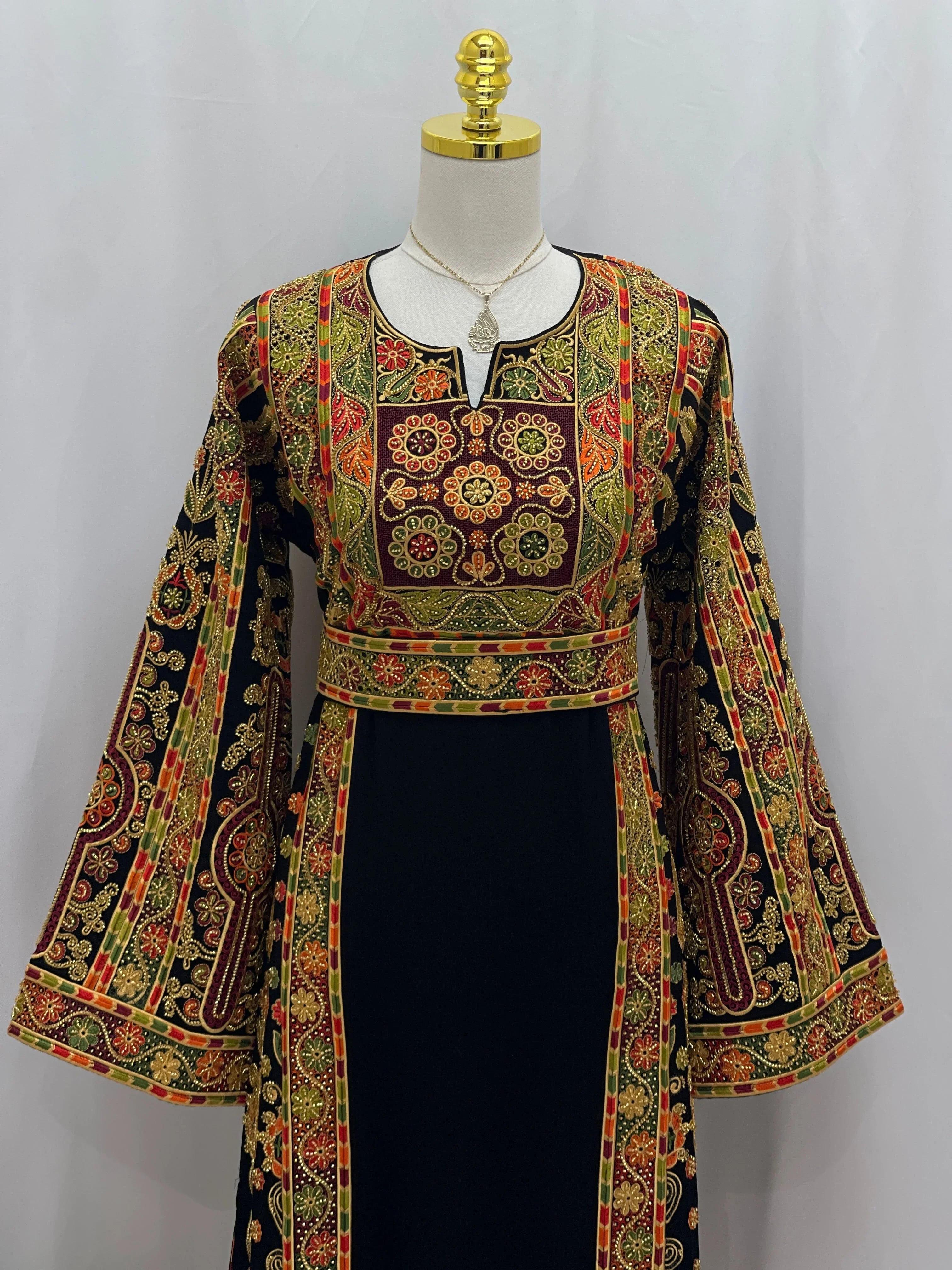 Palestinian Thoub with Beaded Embroidery by Palestinian Elegance black dress with red gold green floral panels and bell sleeves