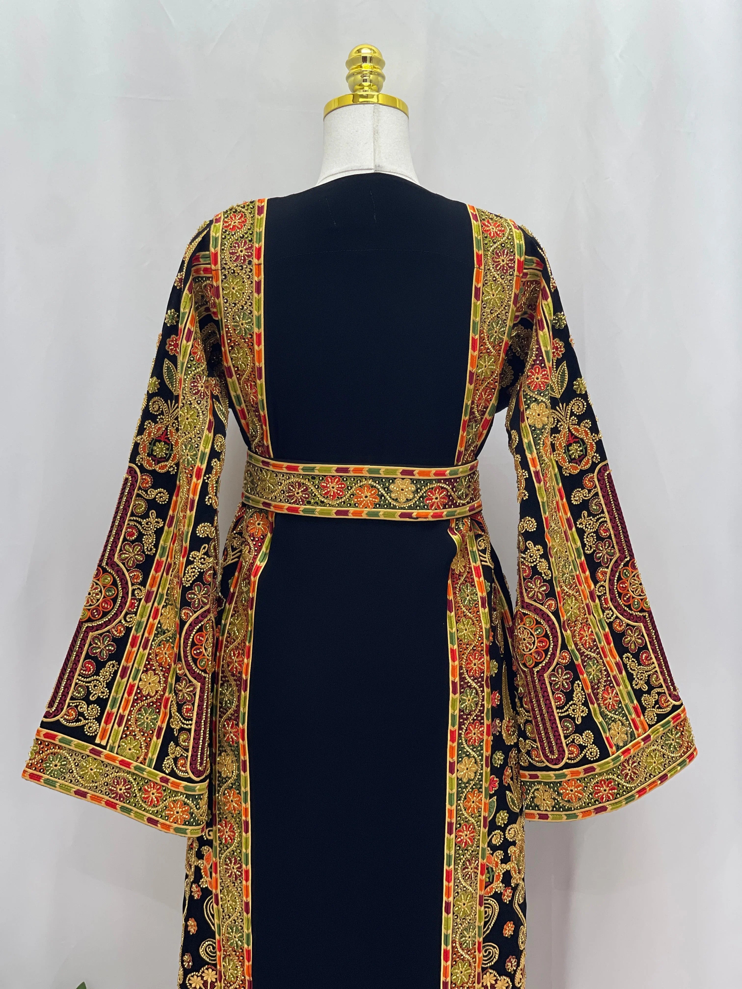 Palestinian Thoub with Beaded Embroidery black dress back view with gold red green embroidered panels and wide bell sleeves