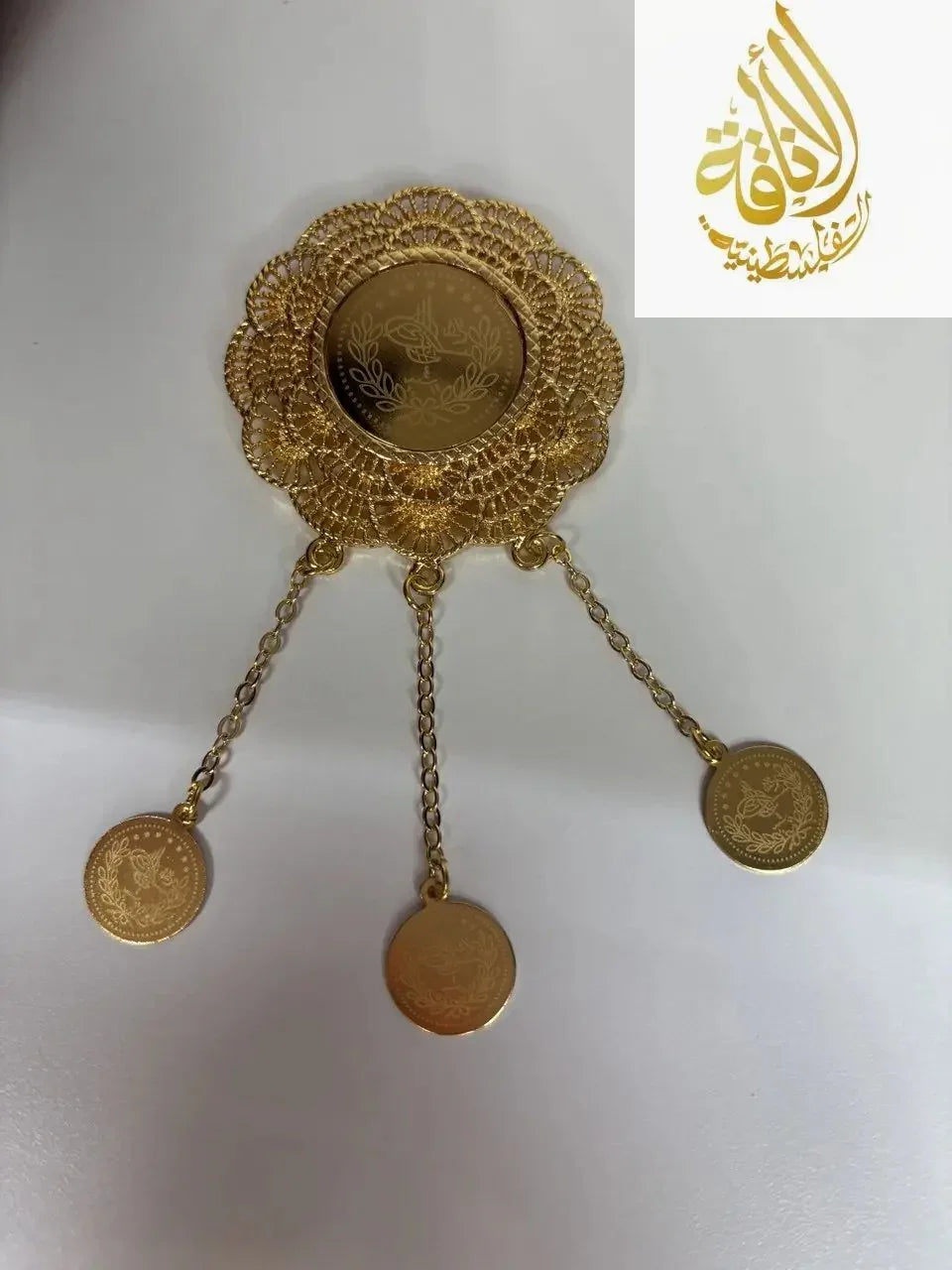 Palestinian Elegance Triple Circle Imitated Gold Pin with intricate floral design and three hanging charms