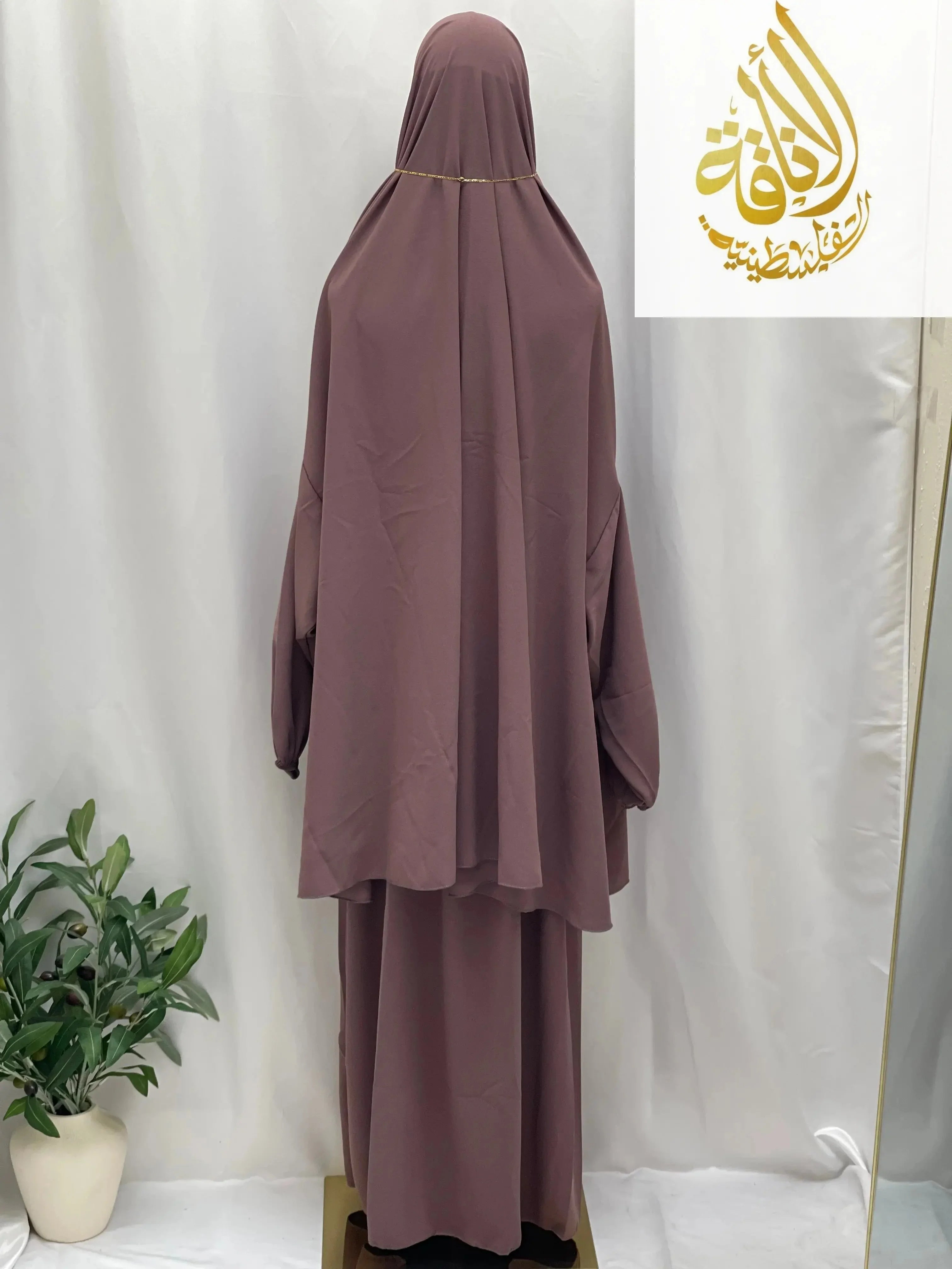 Palestinian Elegance modest mauve two piece prayer outfit displayed on a mannequin with long loose top and skirt