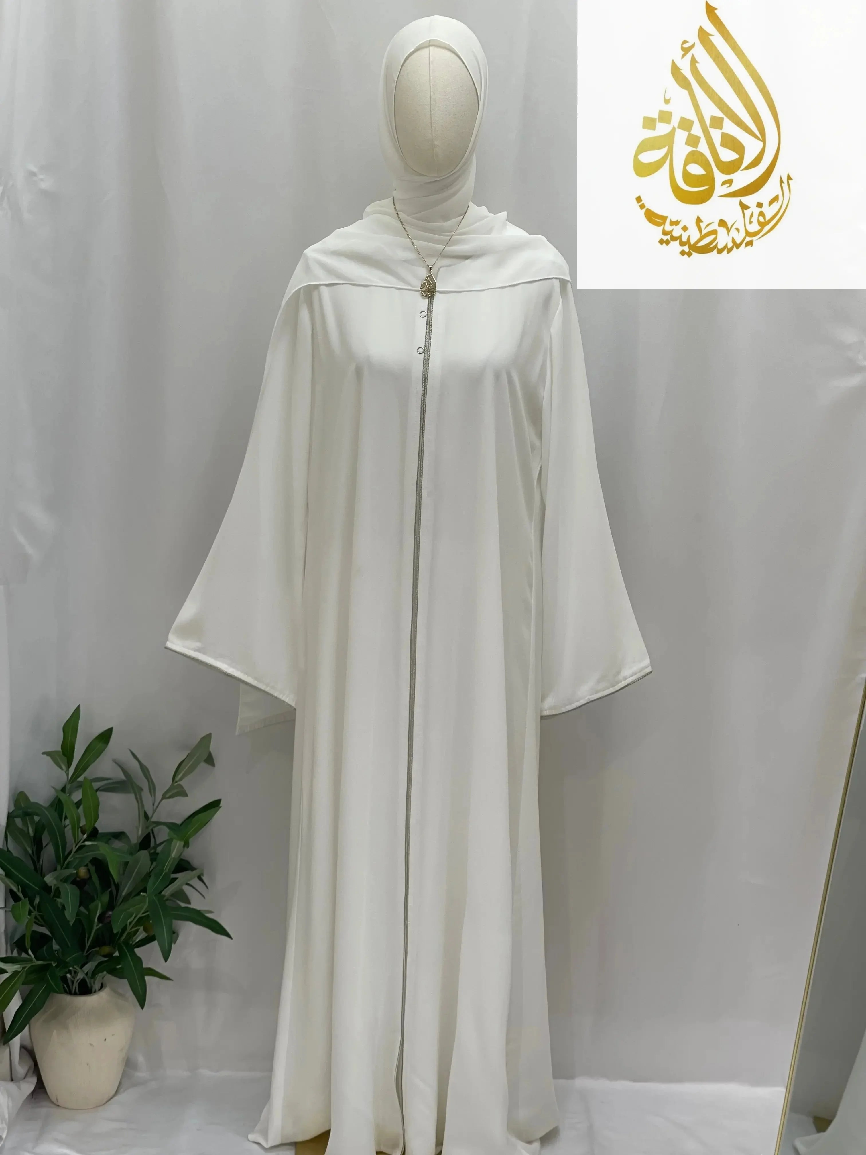 Modest umra abaya with hijab in white from Palestinian Elegance displayed on mannequin