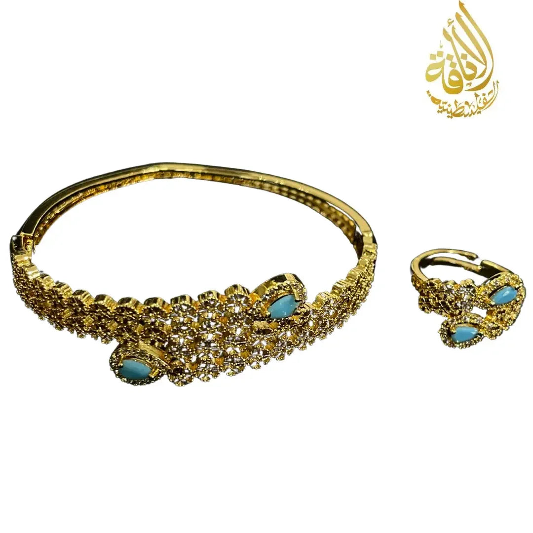 Palestinian gold jewelry set featuring a gold bracelet and ring with turquoise stones and intricate design