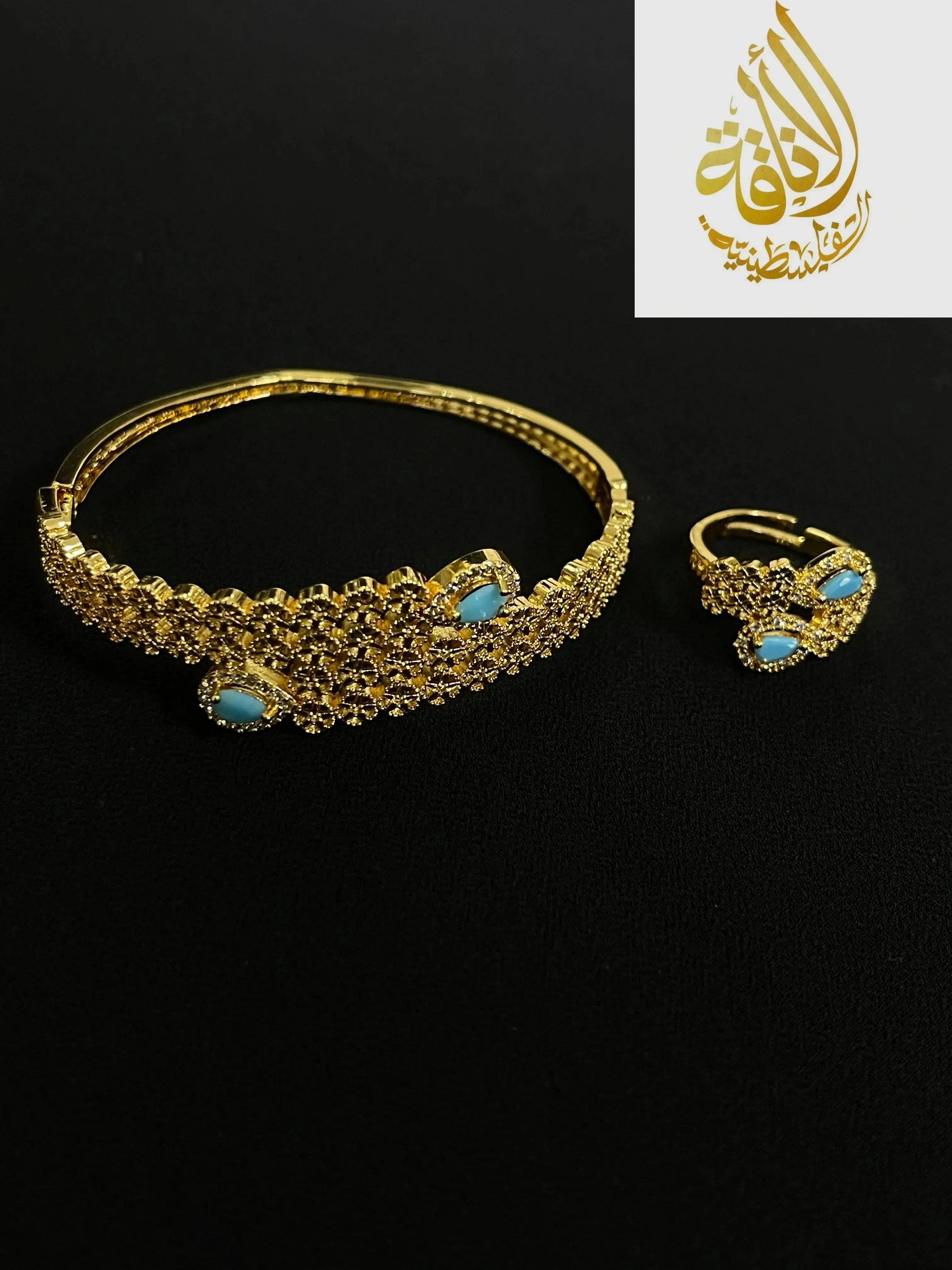 Palestinian gold jewelry set with intricate gold design and turquoise gemstones on black background