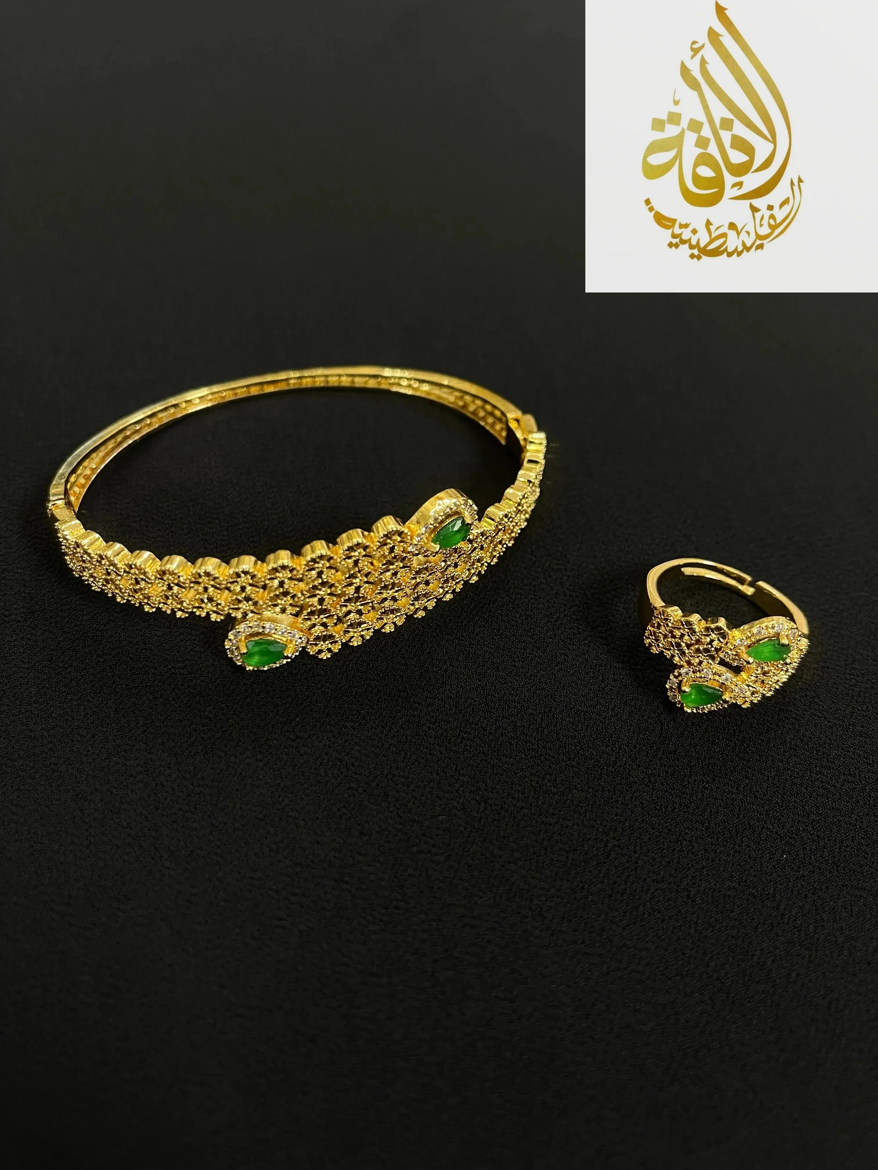 Palestinian gold jewelry set featuring gold bracelet and ring with green stones from Palestinian Elegance