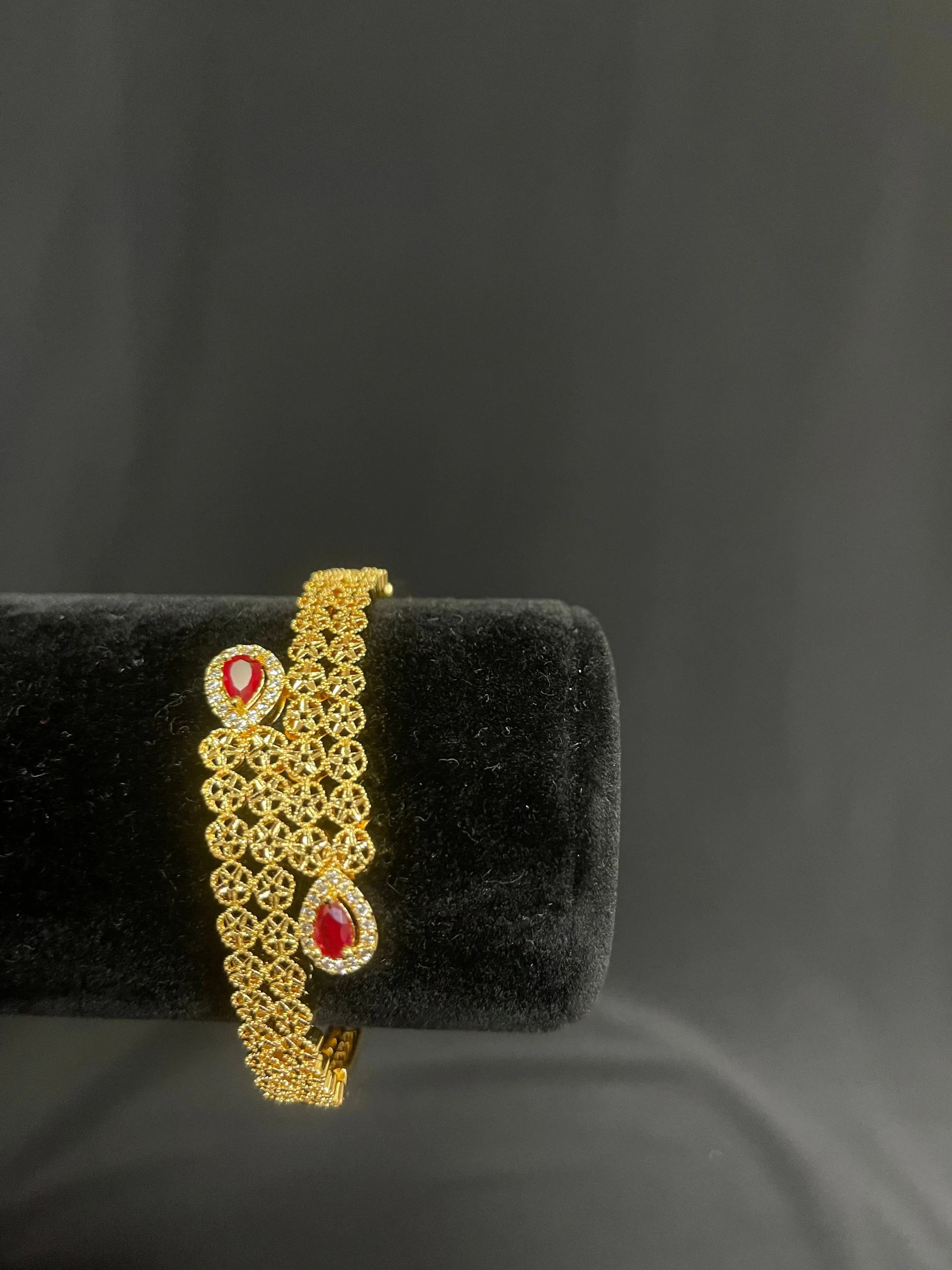 Palestinian gold jewelry set gold bracelet with intricate design and red gemstone accents