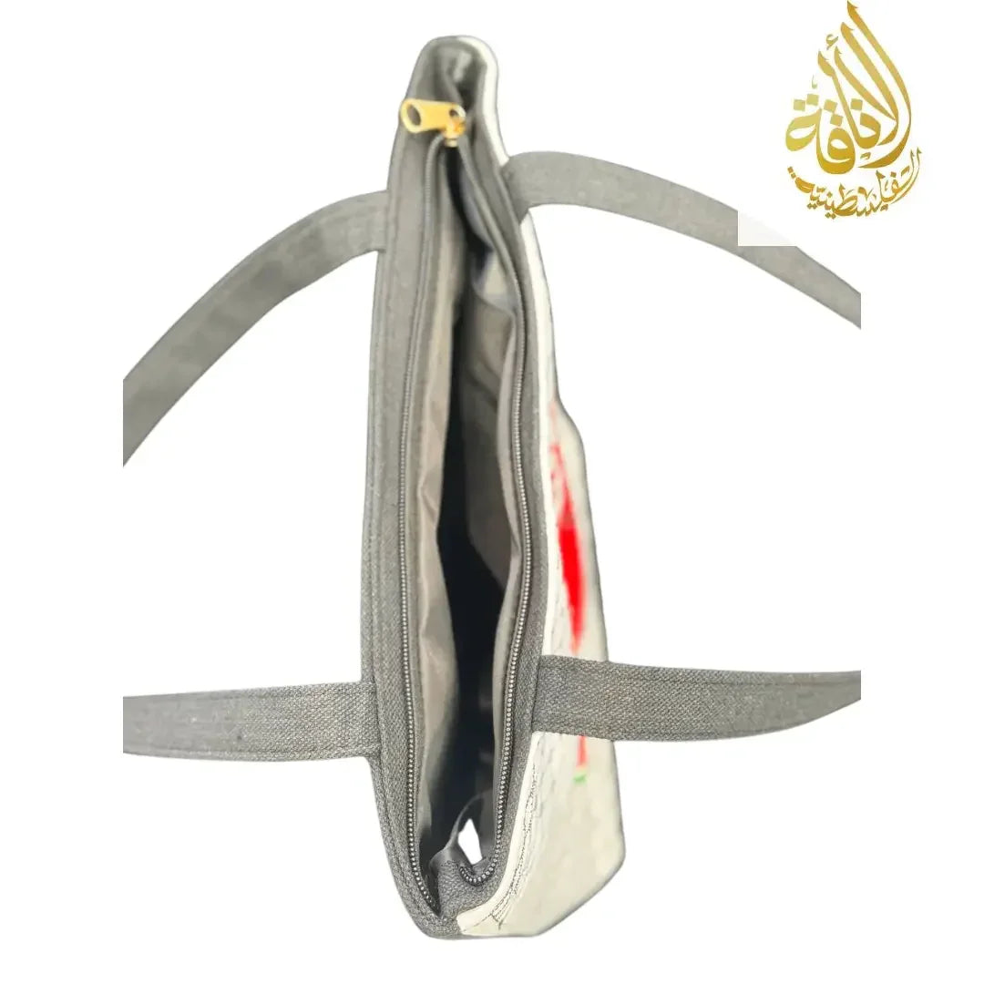 Top view inside zipper of Palestinian watermelon tote bag showing spacious interior and gray straps