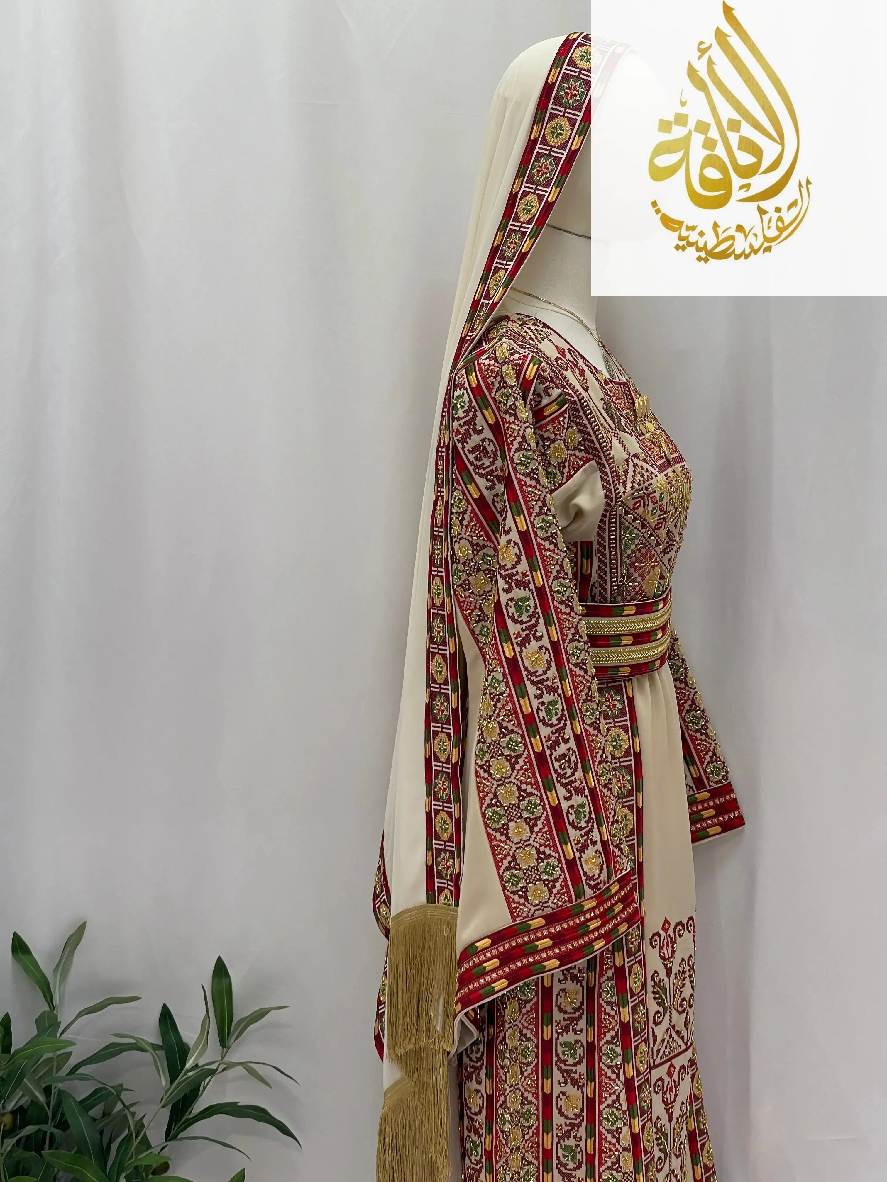 Palestinian Elegance Gold Beads Thoub traditional embroidered dress with matching headpiece on mannequin