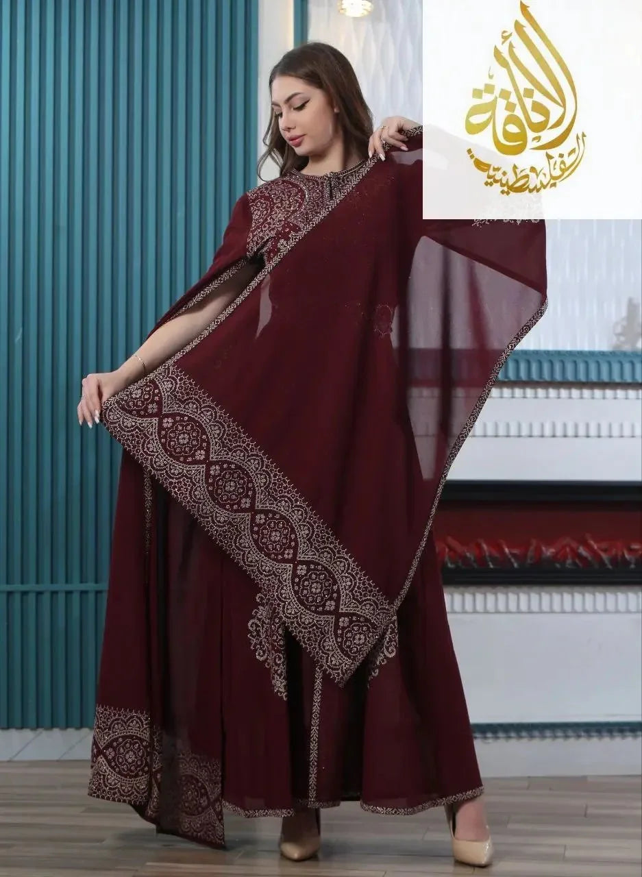 Palestinian Elegance embroidered kaftan dress in rich maroon with intricate white embroidery and flowing sleeves