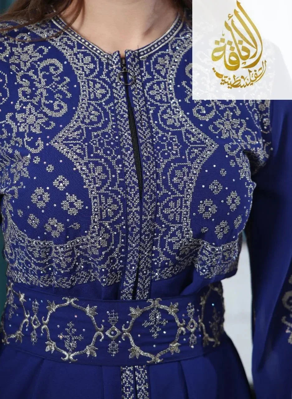 Close-up of Palestinian Elegance embroidered kaftan dress in deep blue with intricate silver embroidery and zipper front