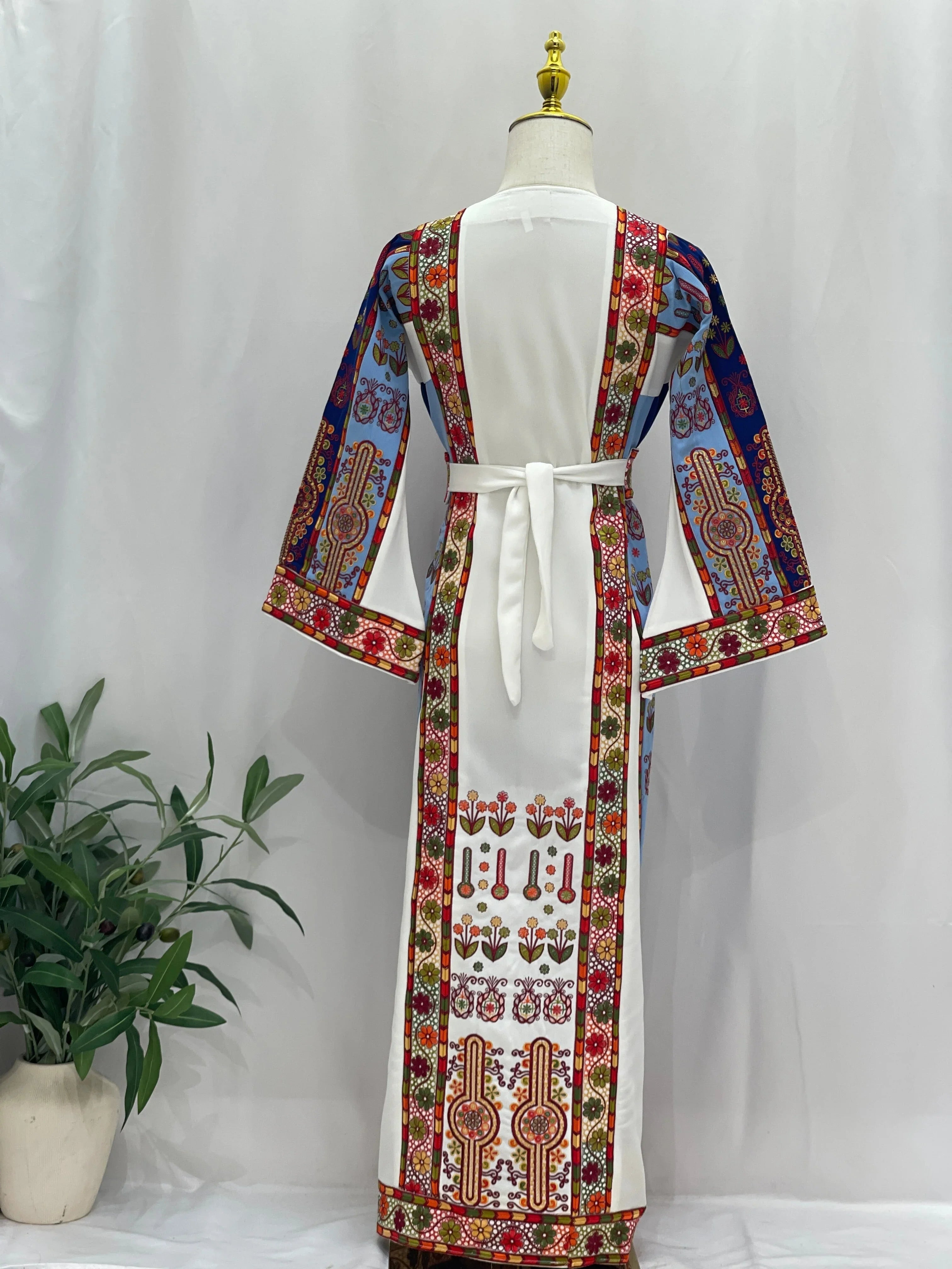 Back view of Embroidered Girls Thoub with colorful floral patterns and bell sleeves from Palestinian Elegance