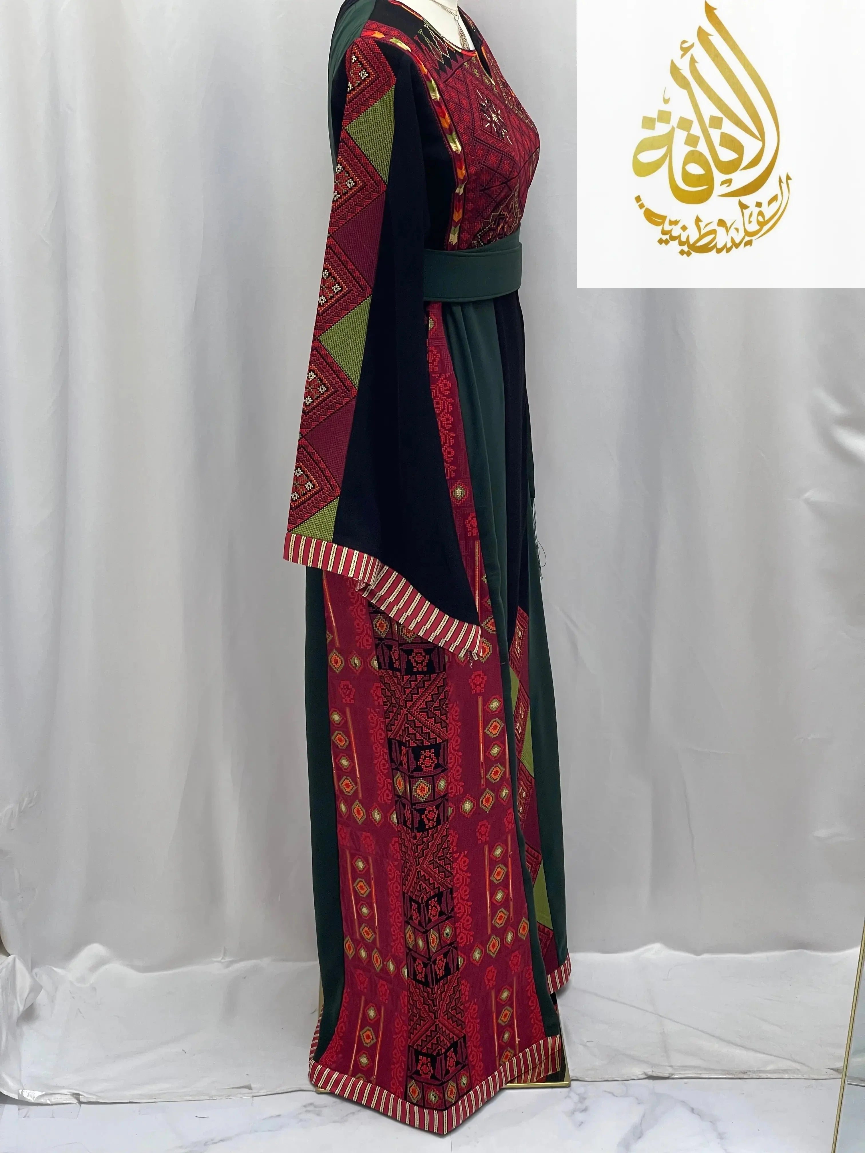 Embroidered Palestinian thoub in red and green traditional patterns by Palestinian Elegance