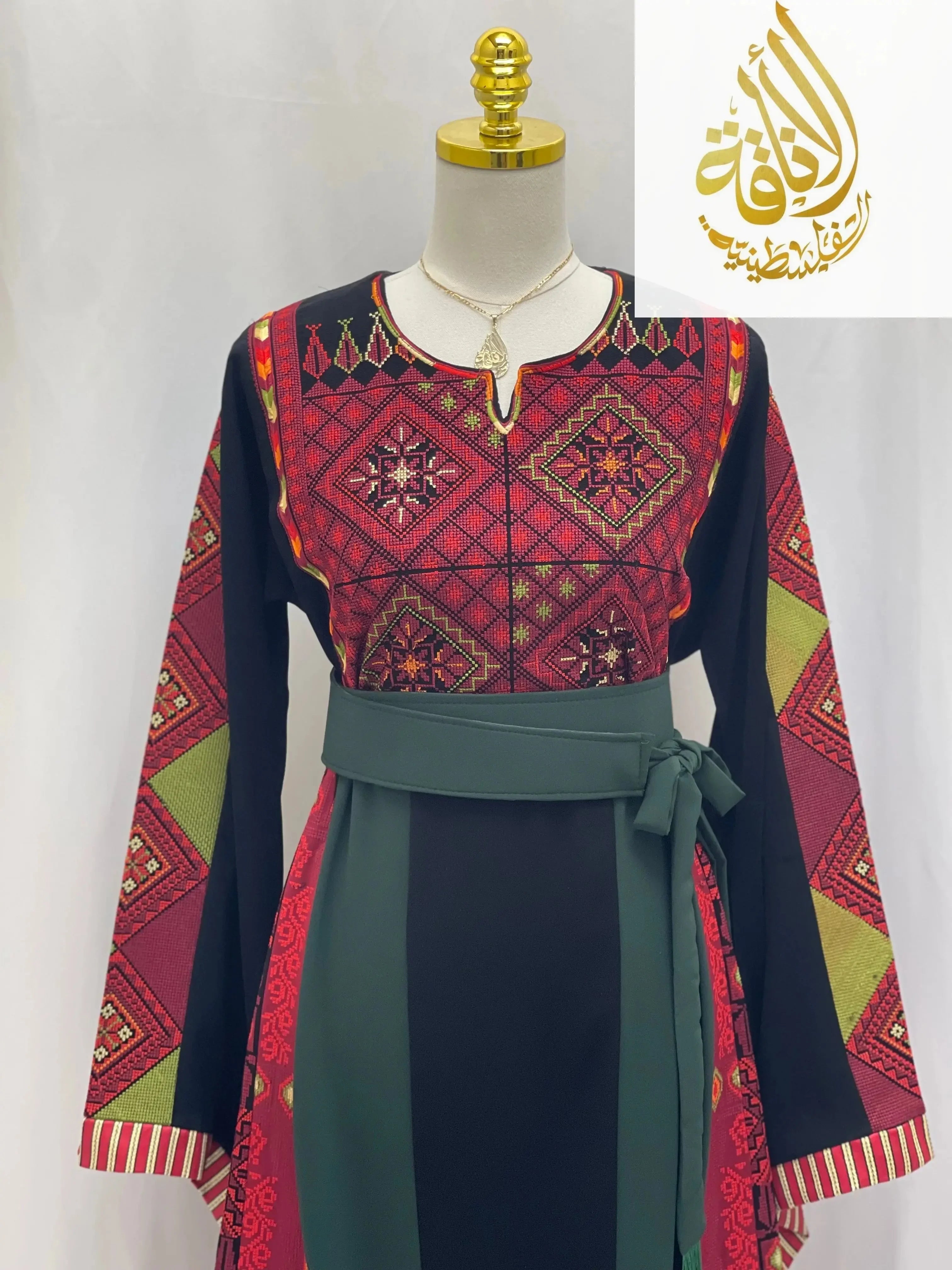 Embroidered Palestinian thoub with traditional red patterns and black background from Palestinian Elegance