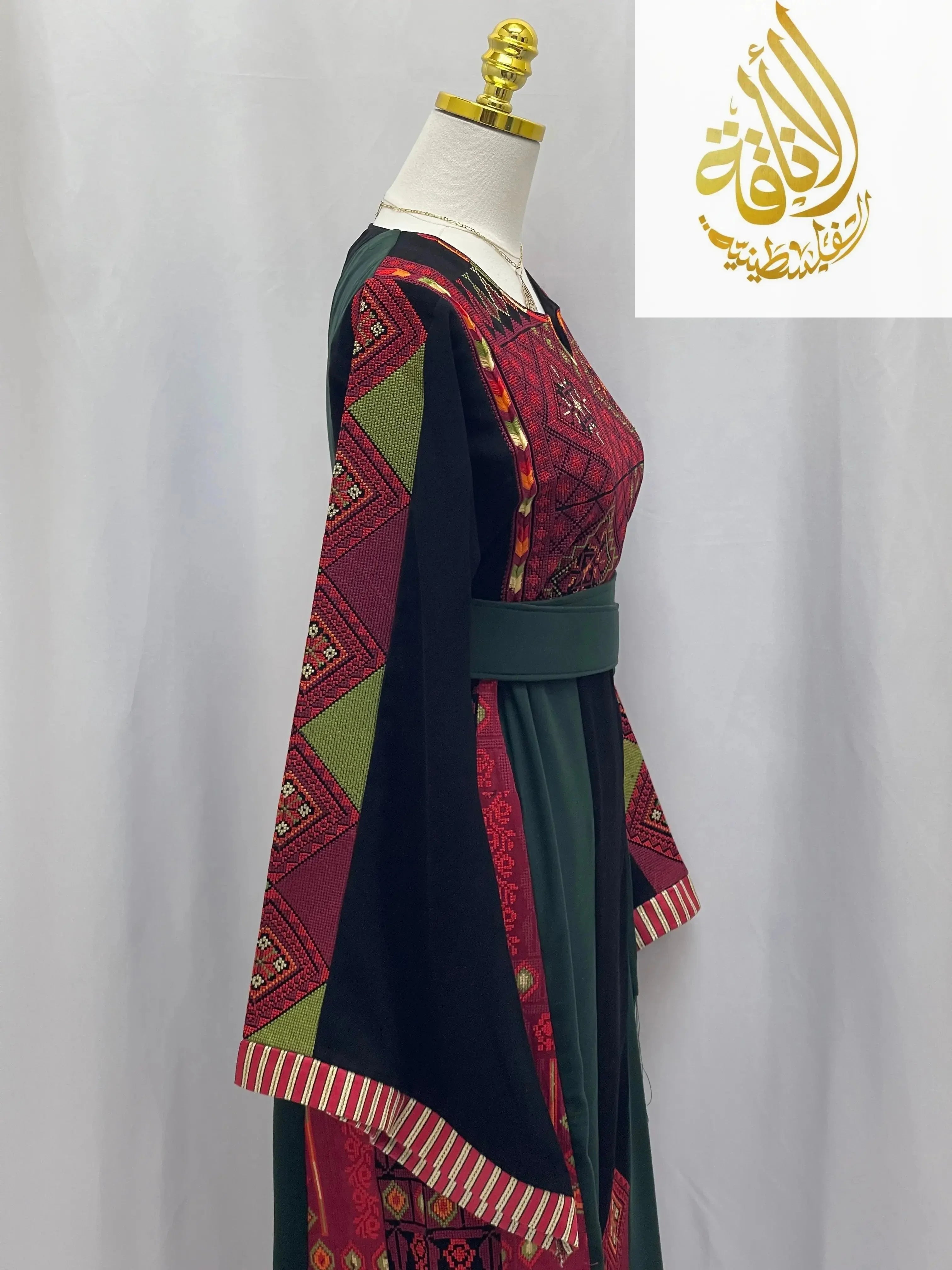 Embroidered Palestinian thoub by Palestinian Elegance with traditional red and green patterns